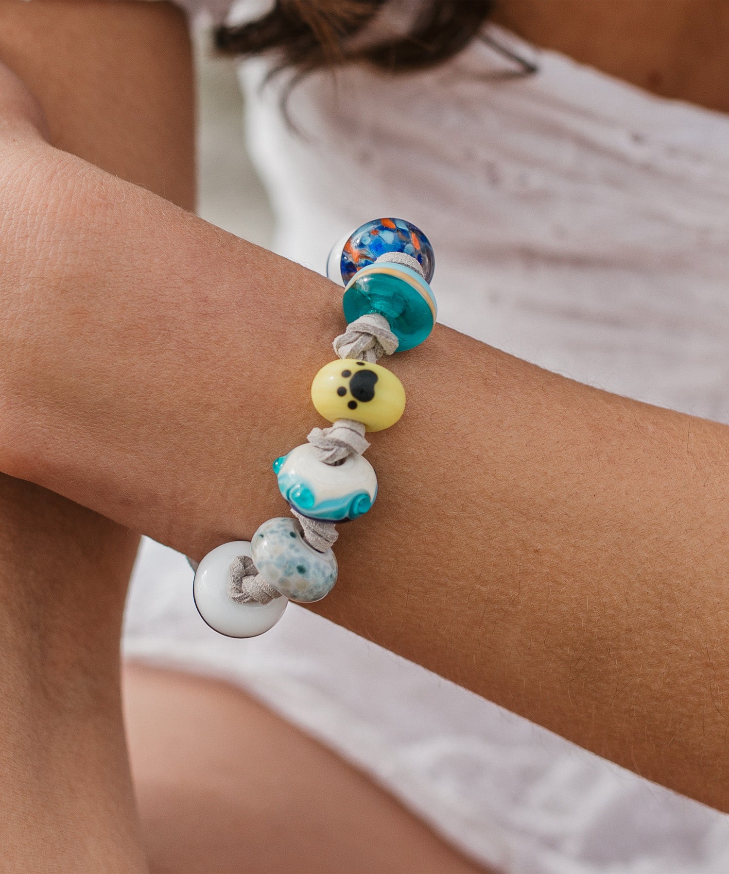Colourful glass beads on a bracelet representing charities.