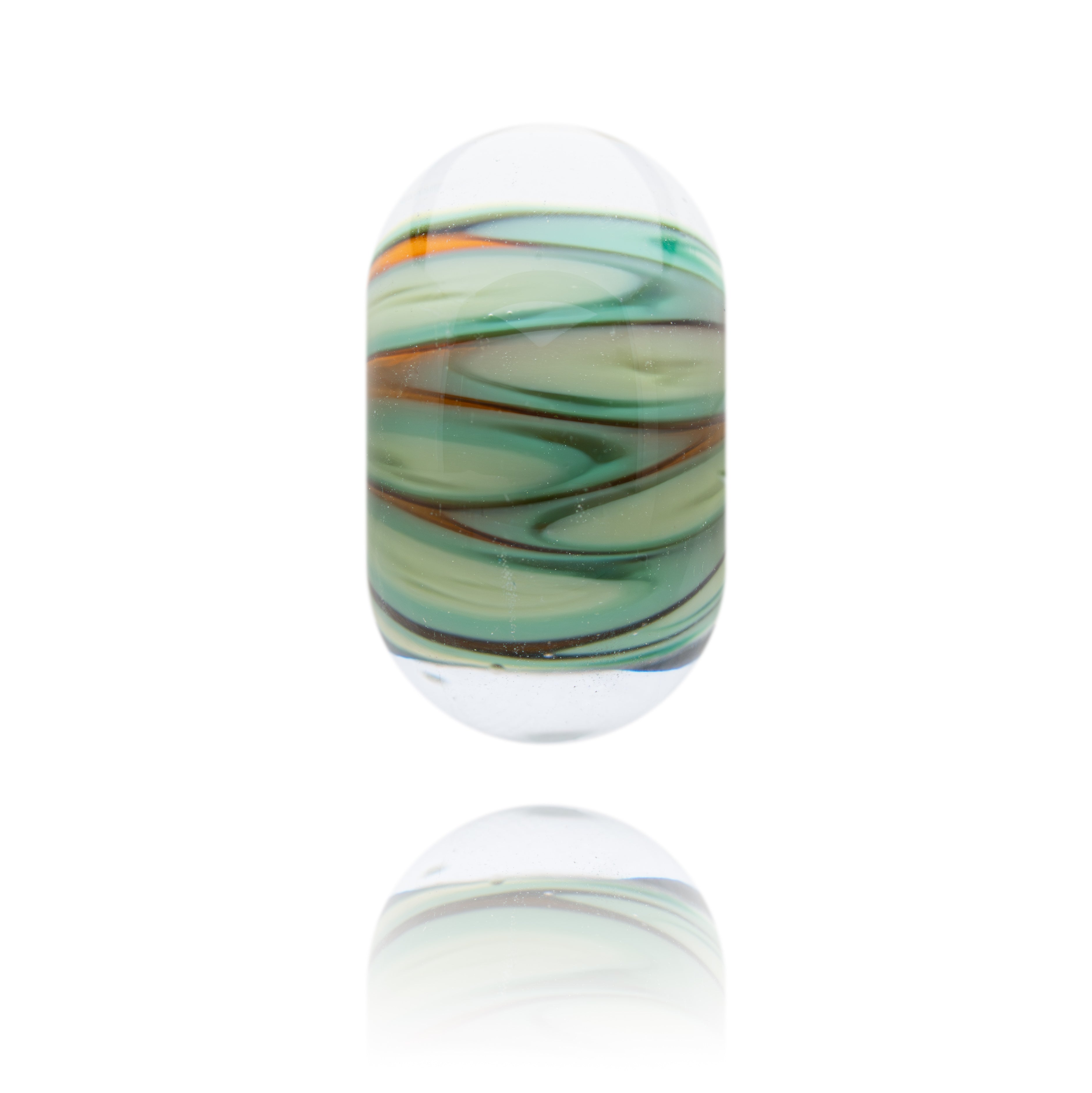 Glass bead with green and brown swirls on a white background