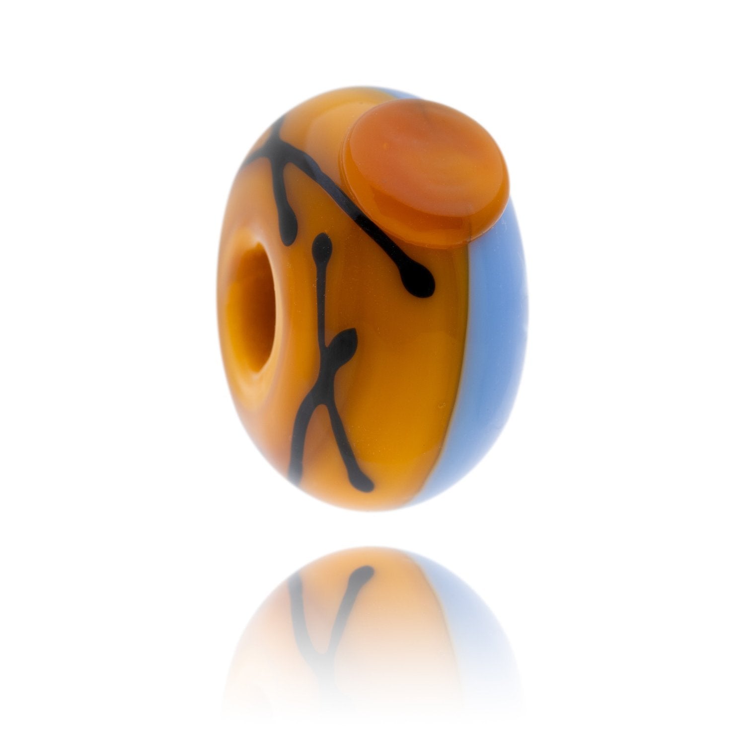 Blue and yellow glass bead with a yellow dot and black lines on the surface. Representing Cleethorpes beach in Lincolnshire.