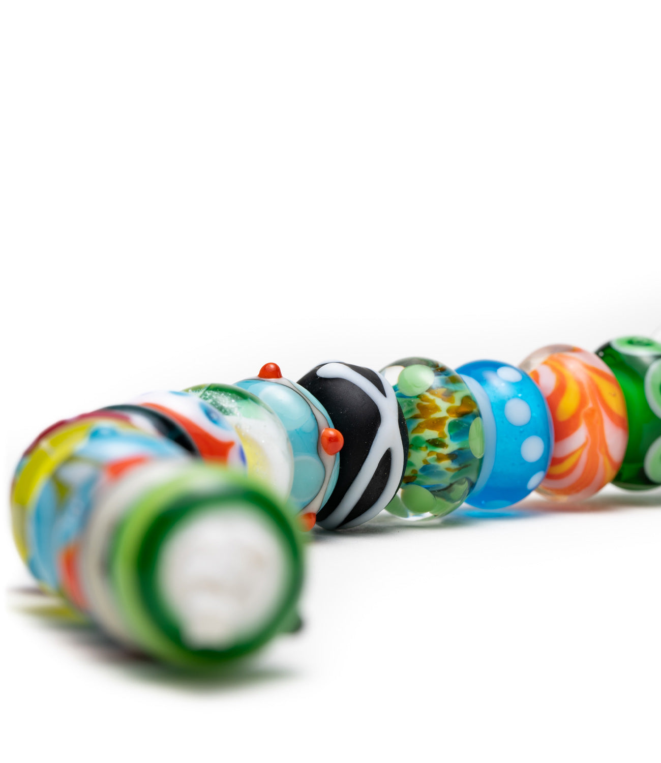 Bright, colourful Murano glass beads in a row.