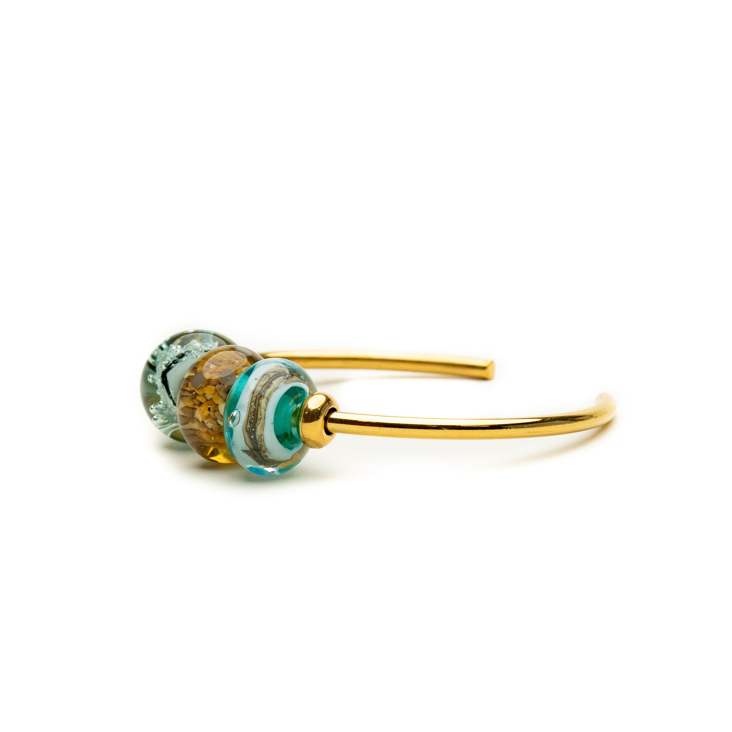 Gold bangle with green, blue and brown glass surf inspired beads.