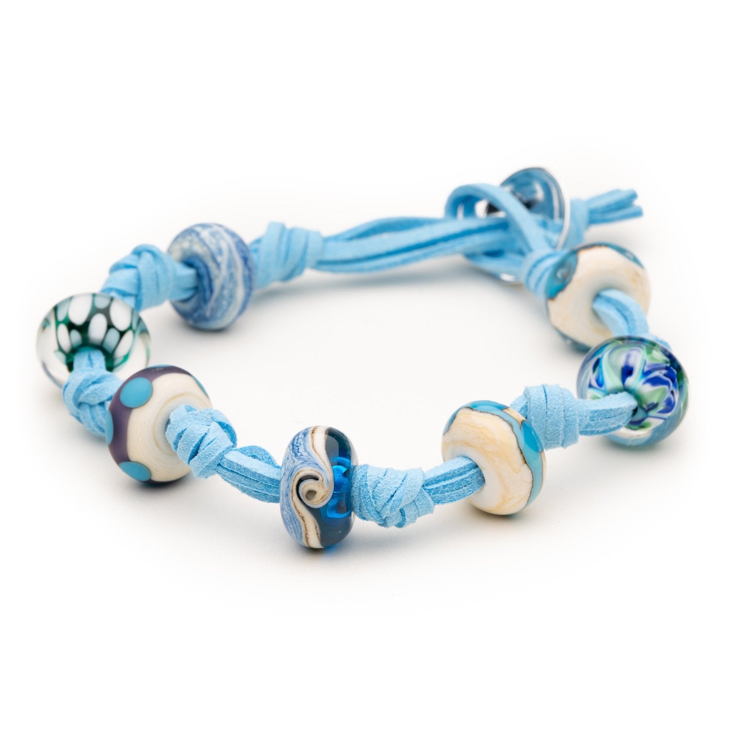 Blue cord bracelet with colourful patterned glass beads representing Cornish beaches.