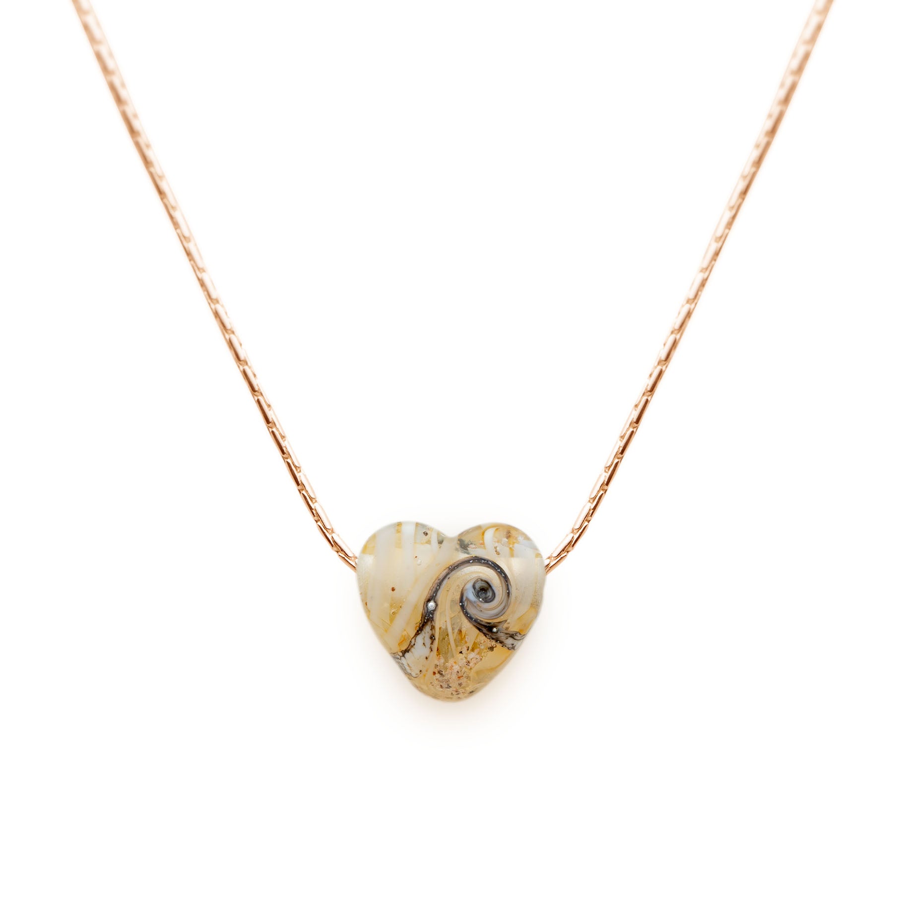 Cream glass sand heart bead on gold chain necklace.