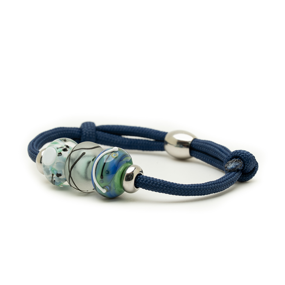 Navy blue bracelet with three beads on a white background