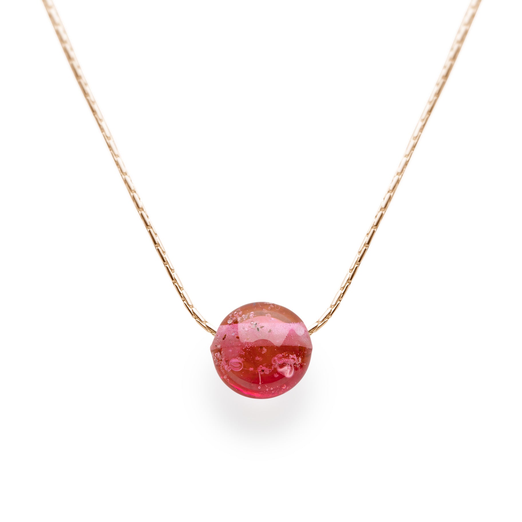 Dark pink glass sand pebble bead on gold chain necklace.