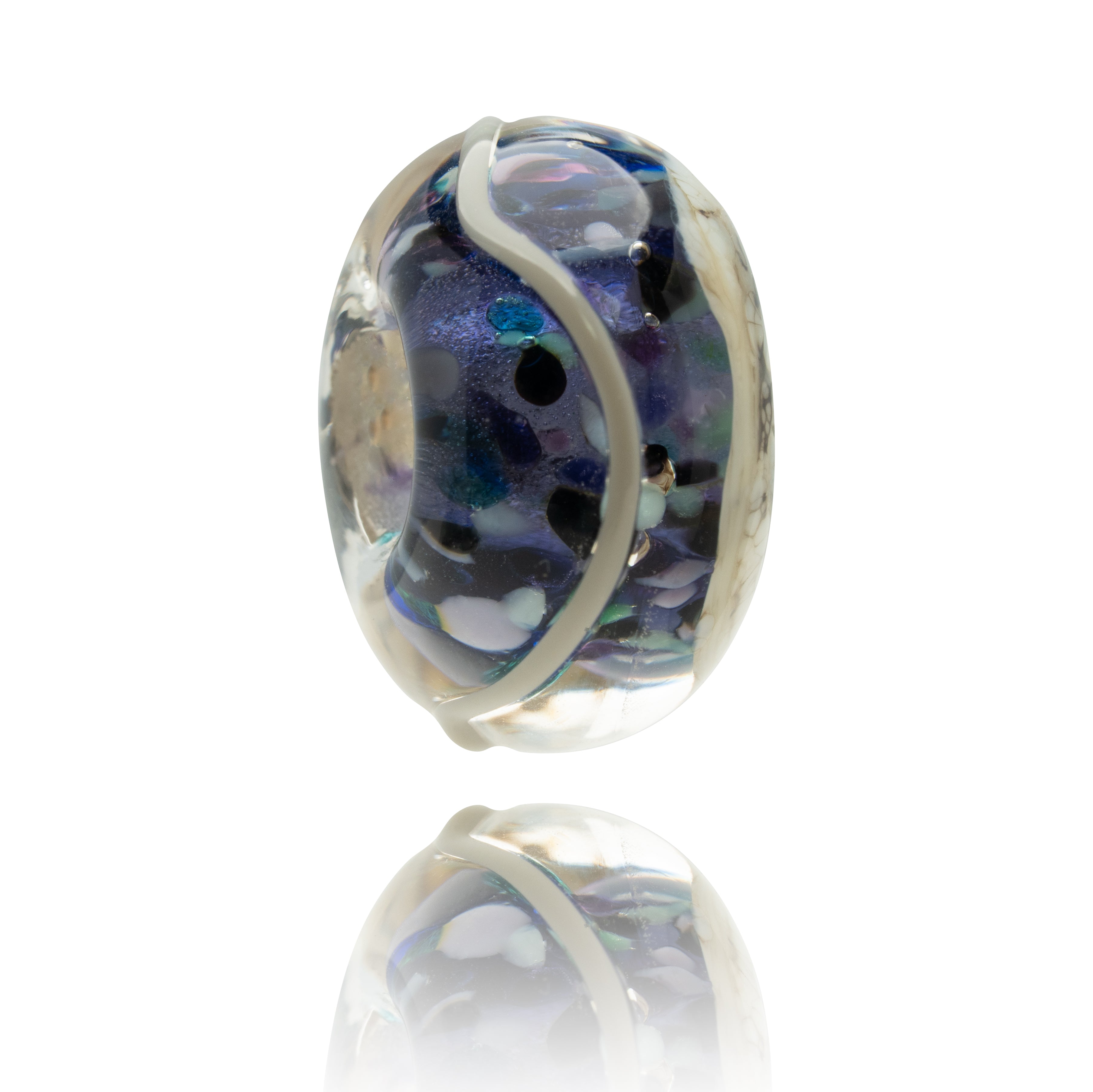 Multicolored glass bead with white accents on a white background