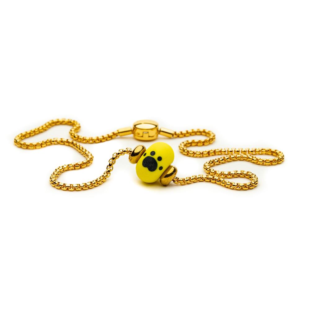 Dogs Trust yellow bead on the Gold Necklace.