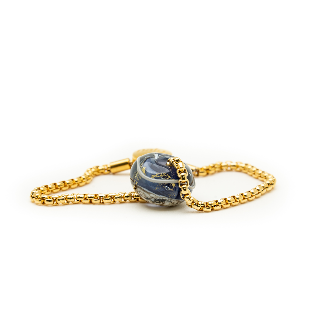 Marble-textured bead with a gold chain on a white background
