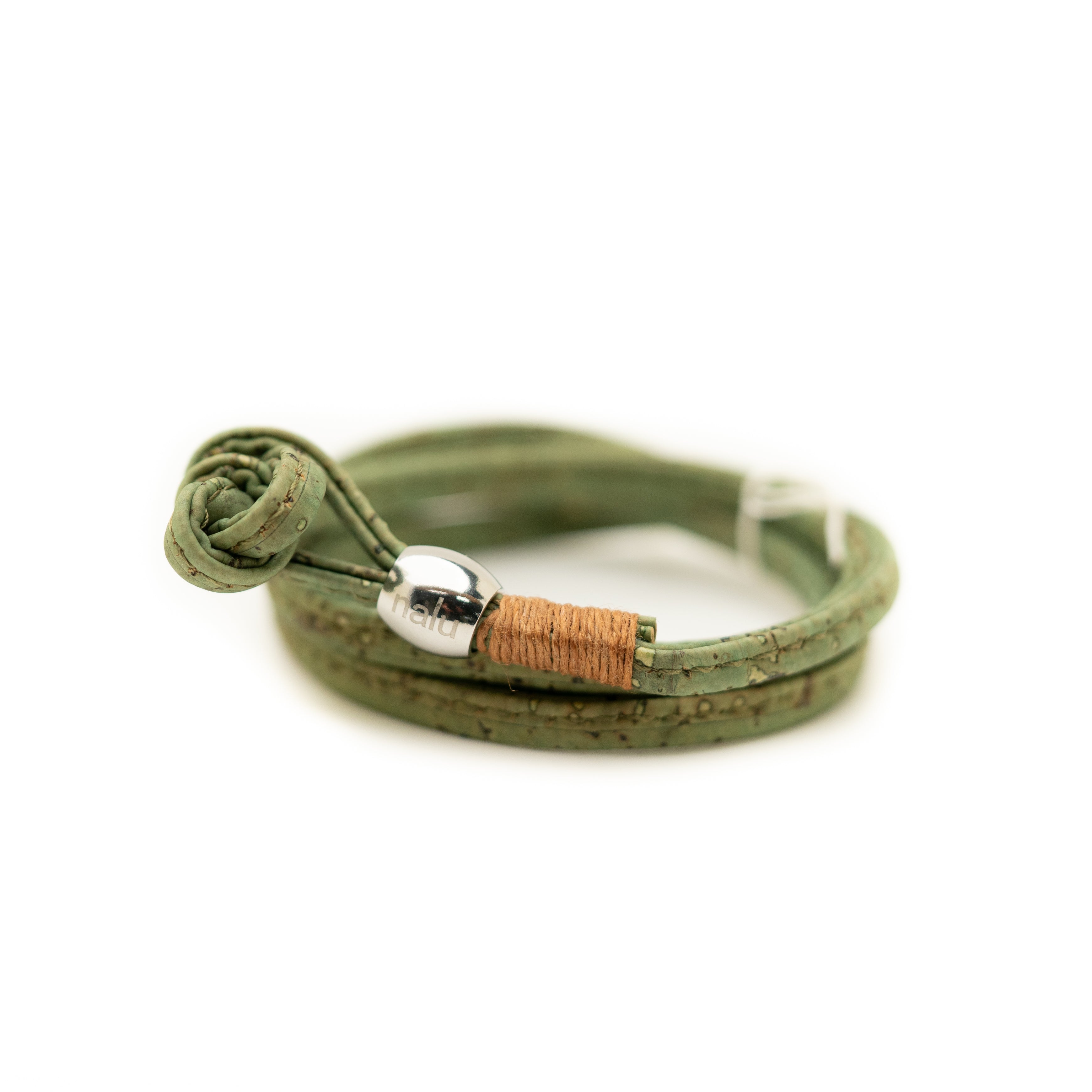 Green leather bracelet with a silver and cork bead on a white background