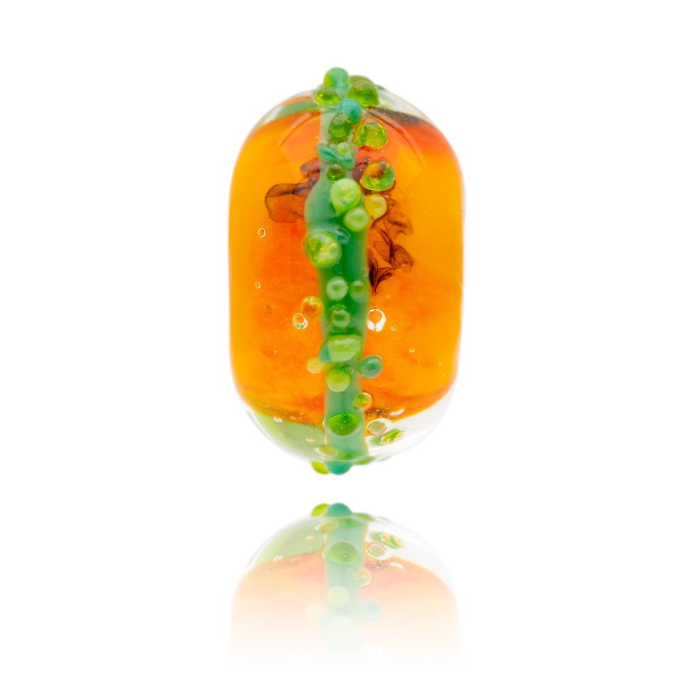 Bright orange glass bead with green surf dots representing Jamaica.