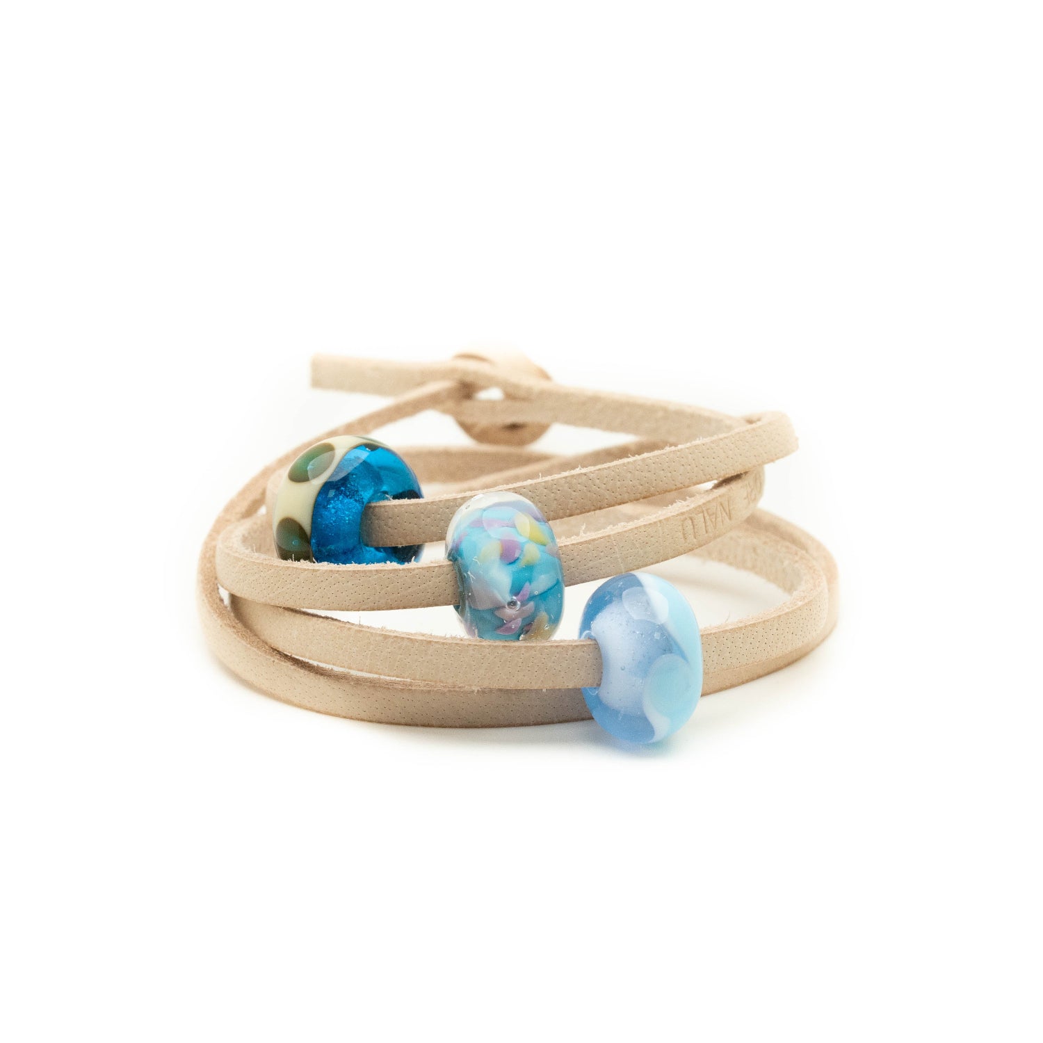 Glass beads in blue and purple shades for Kent on a sand coloured leather strap bracelet.