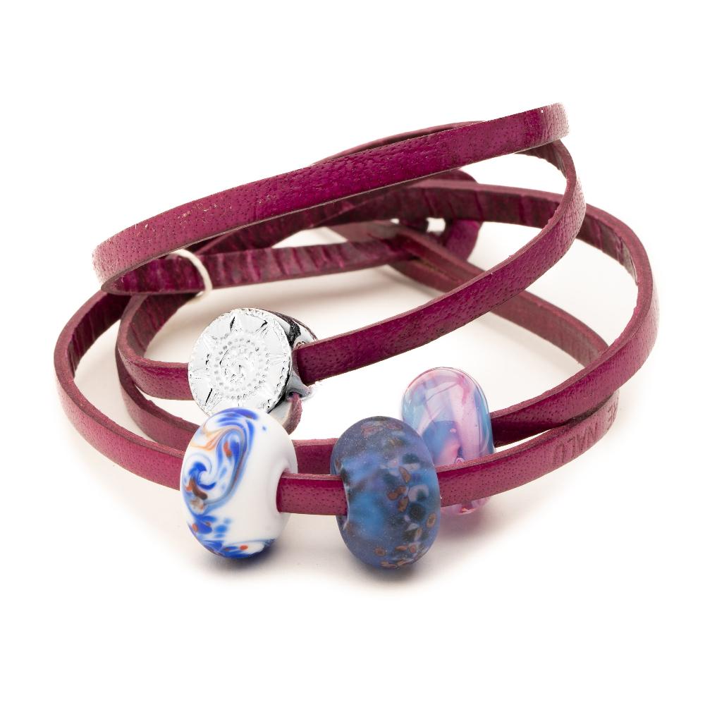 Magenta leather wrap bracelet with three glass beads and a silver compass charm