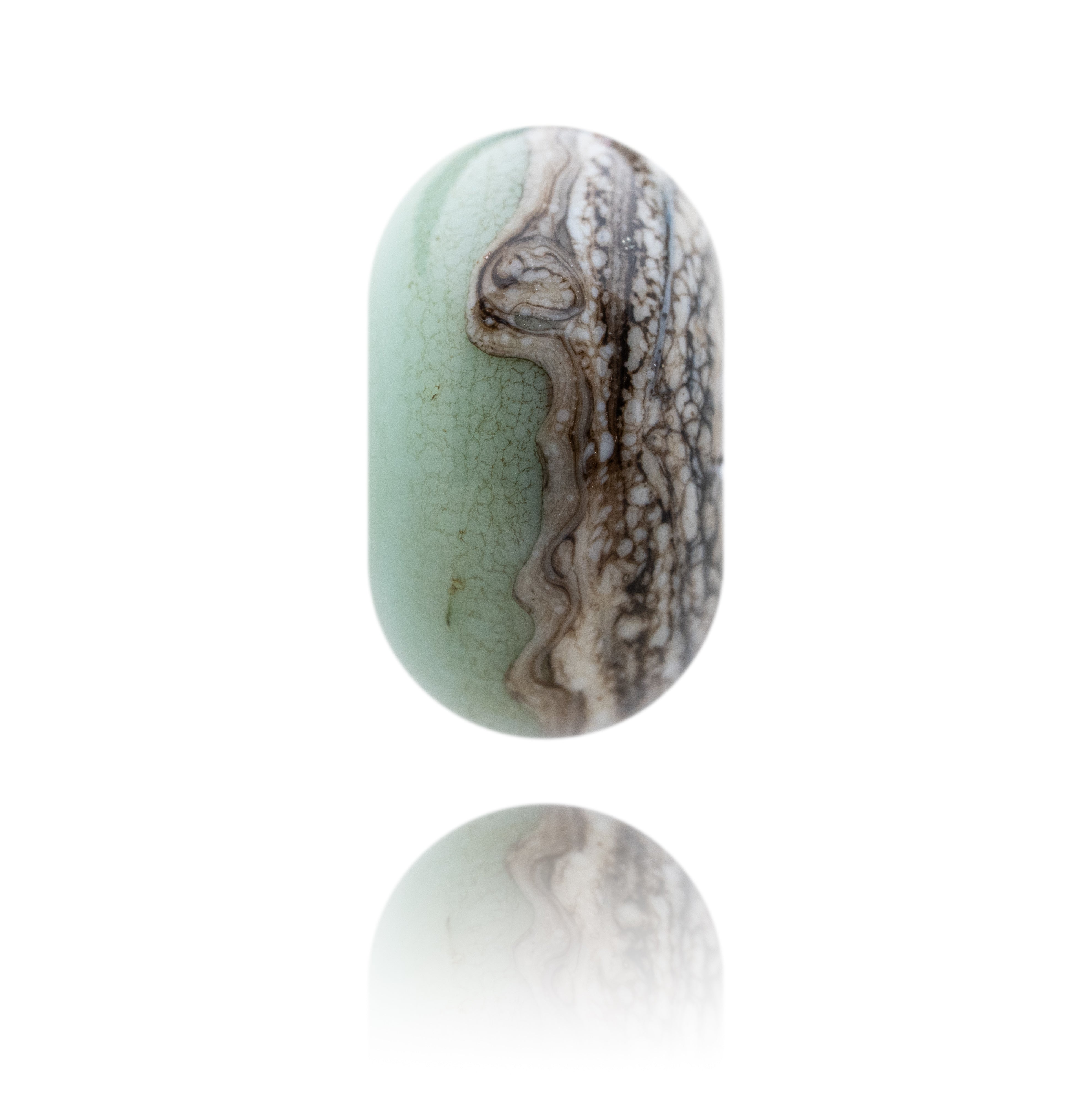 Jadeite jade bead with brown and white patterns on a white background