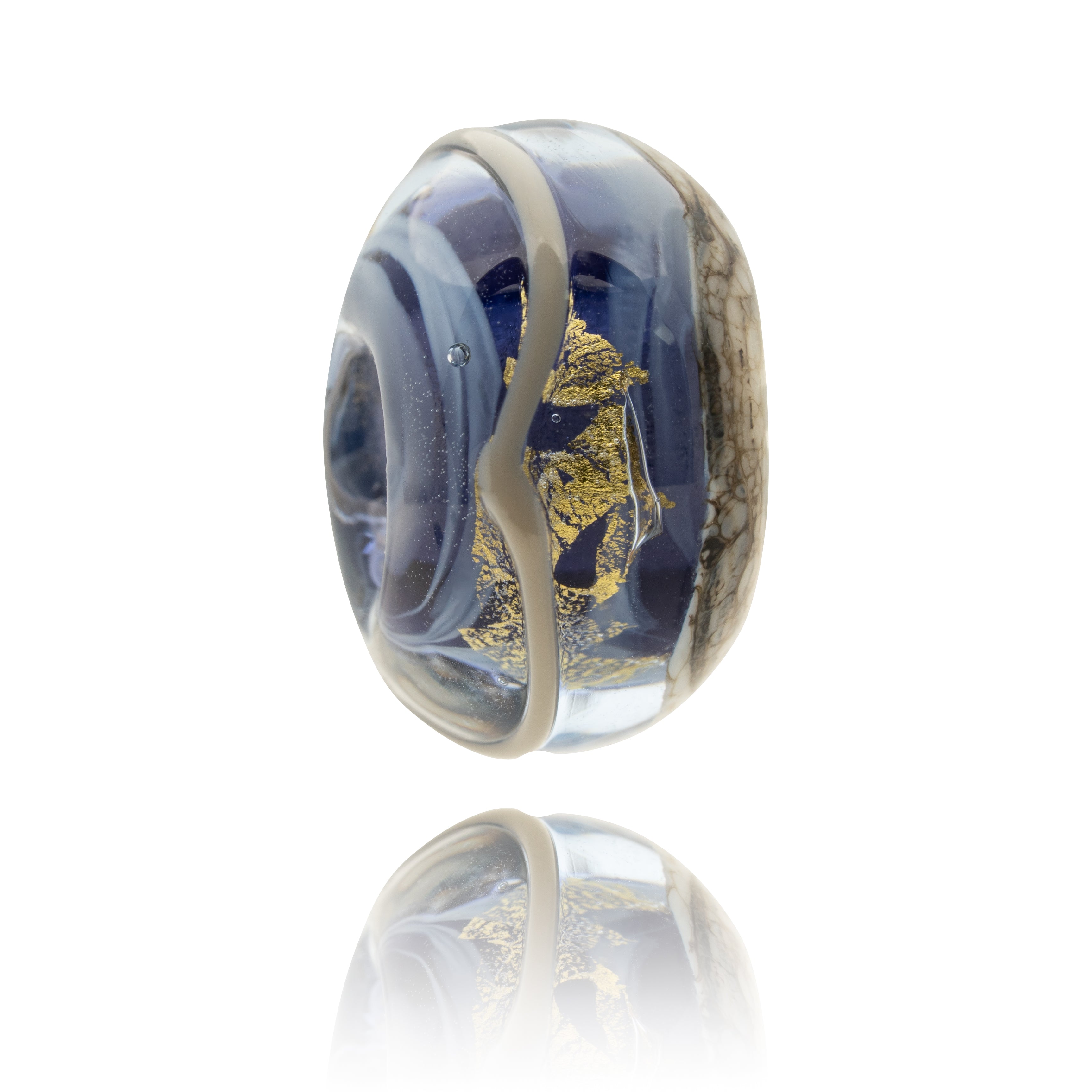 Glass bead with purple and gold design on a white background