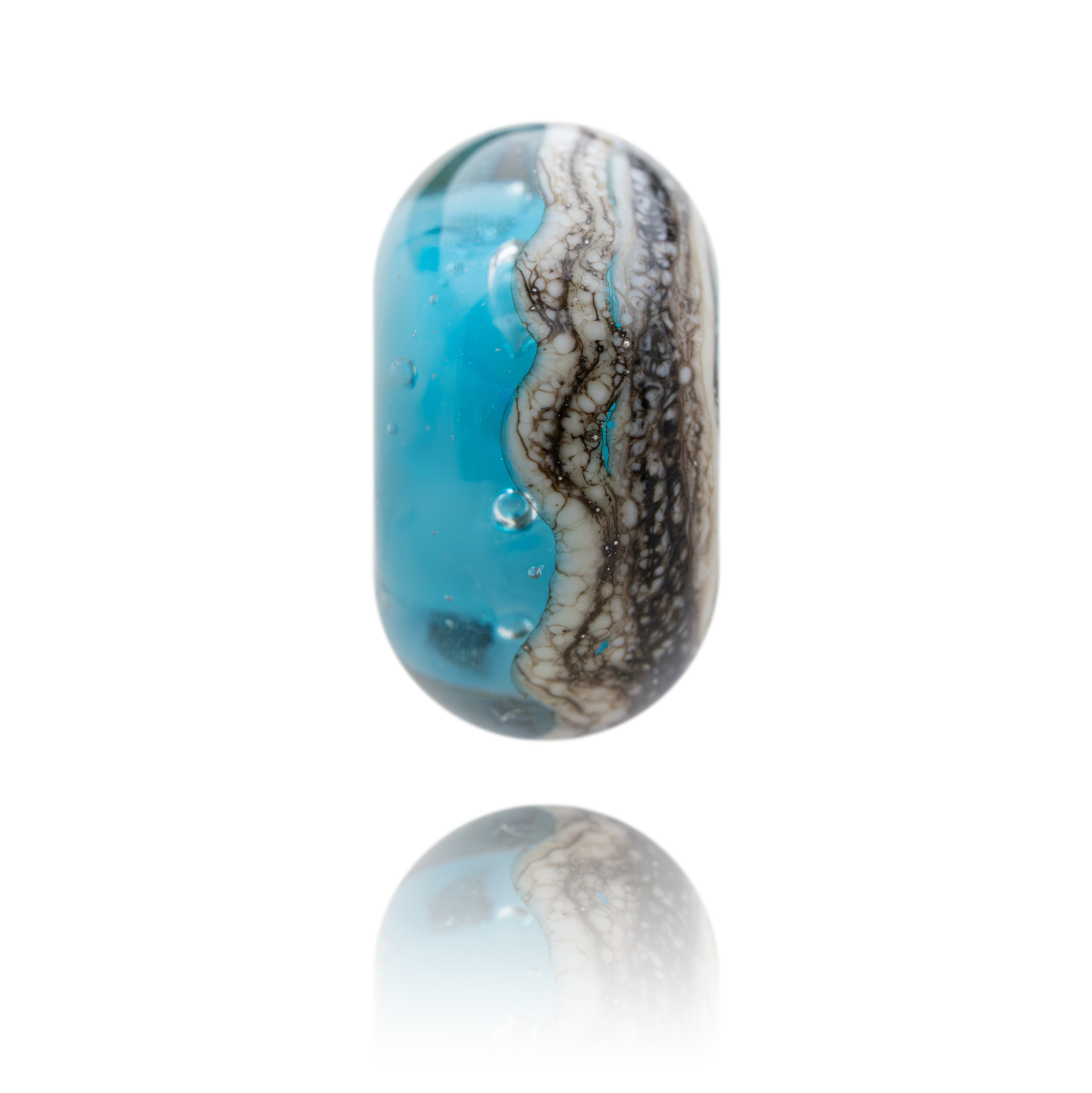 Turquoise and gray patterned cylindrical object on a white background