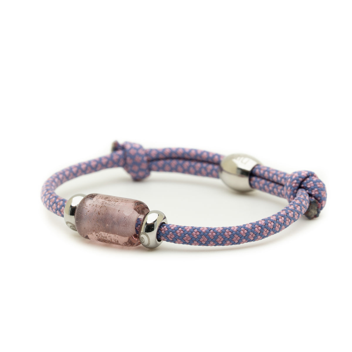 A braided cord bracelet in purple and pink with a central translucent pink glass bead and silver-toned metal accents, shown on a plain white background.