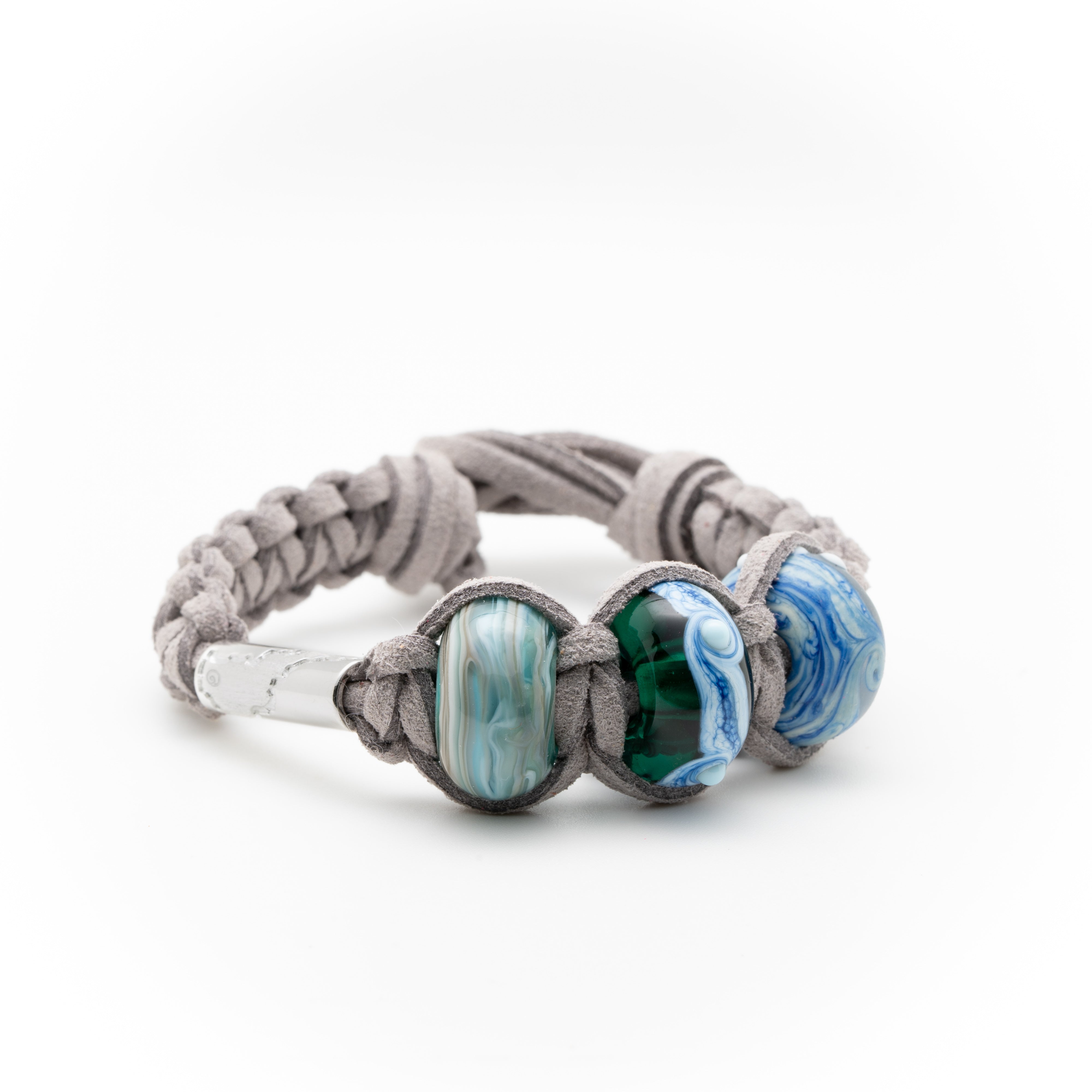 Macrame bracelet made with light grey cord and blue glass beads.