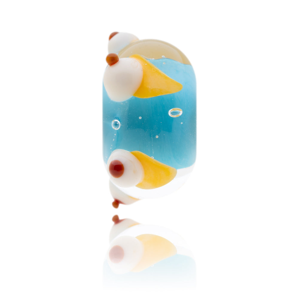 Turquoise and clear glass bead with cream cones decorations around the out side.