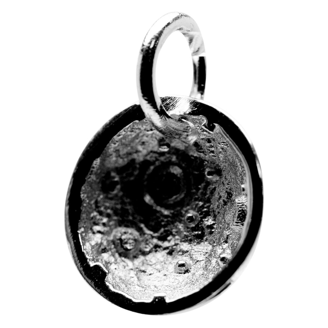 Silver moon pendant with textured surface on a white background