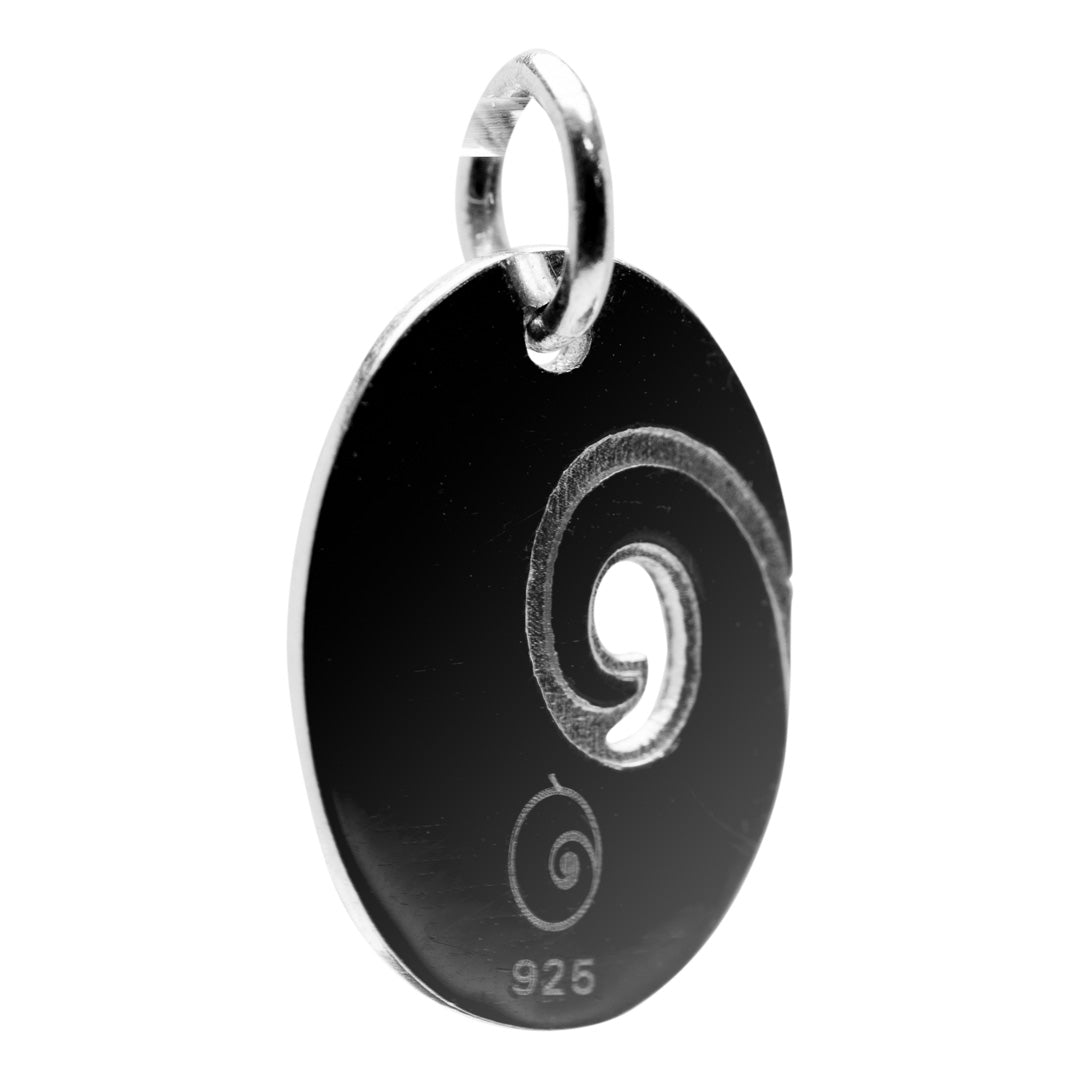 Silver pendant with silver spiral design on a white background
