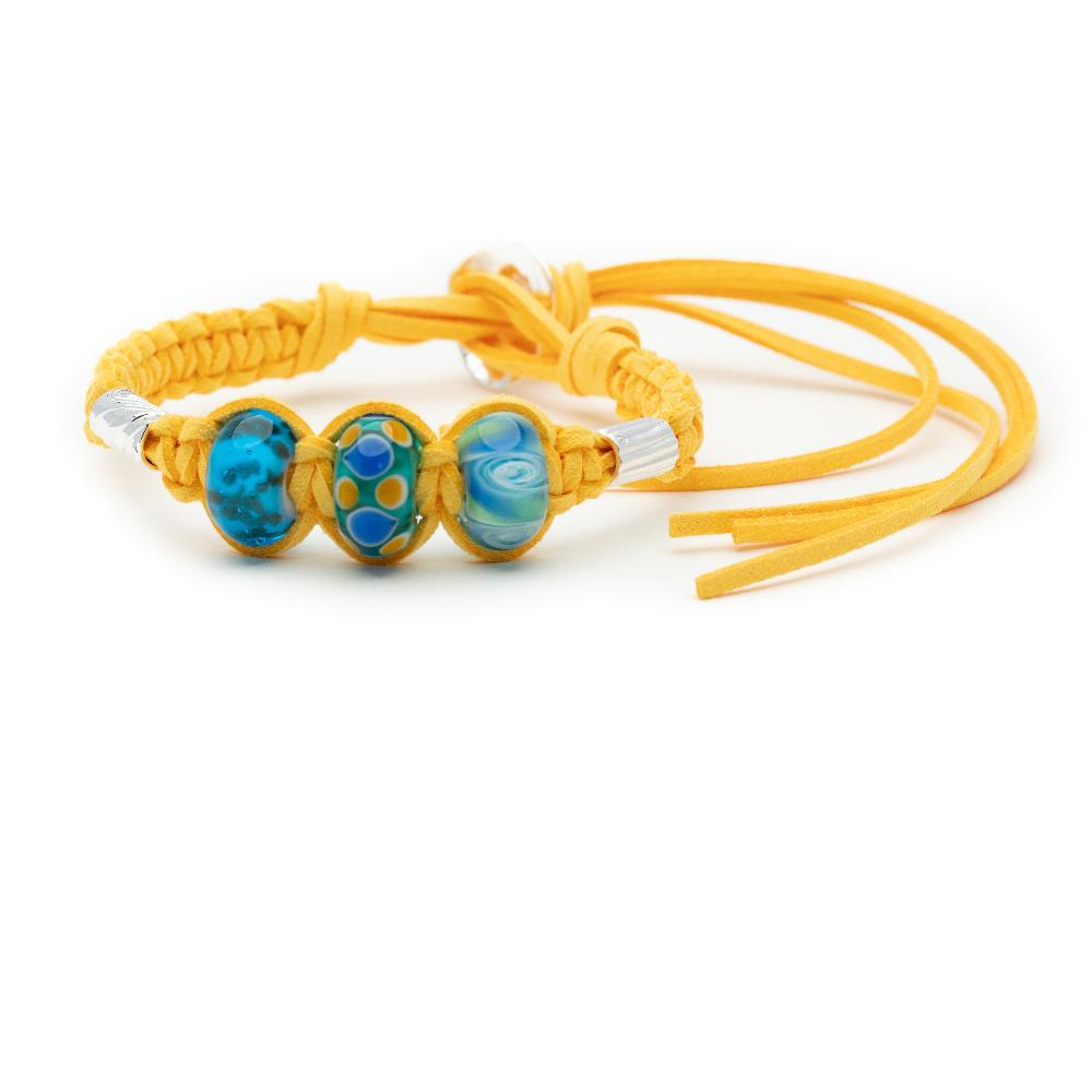 Yellow cord bracelet with three glass beads and two silver tube beads.