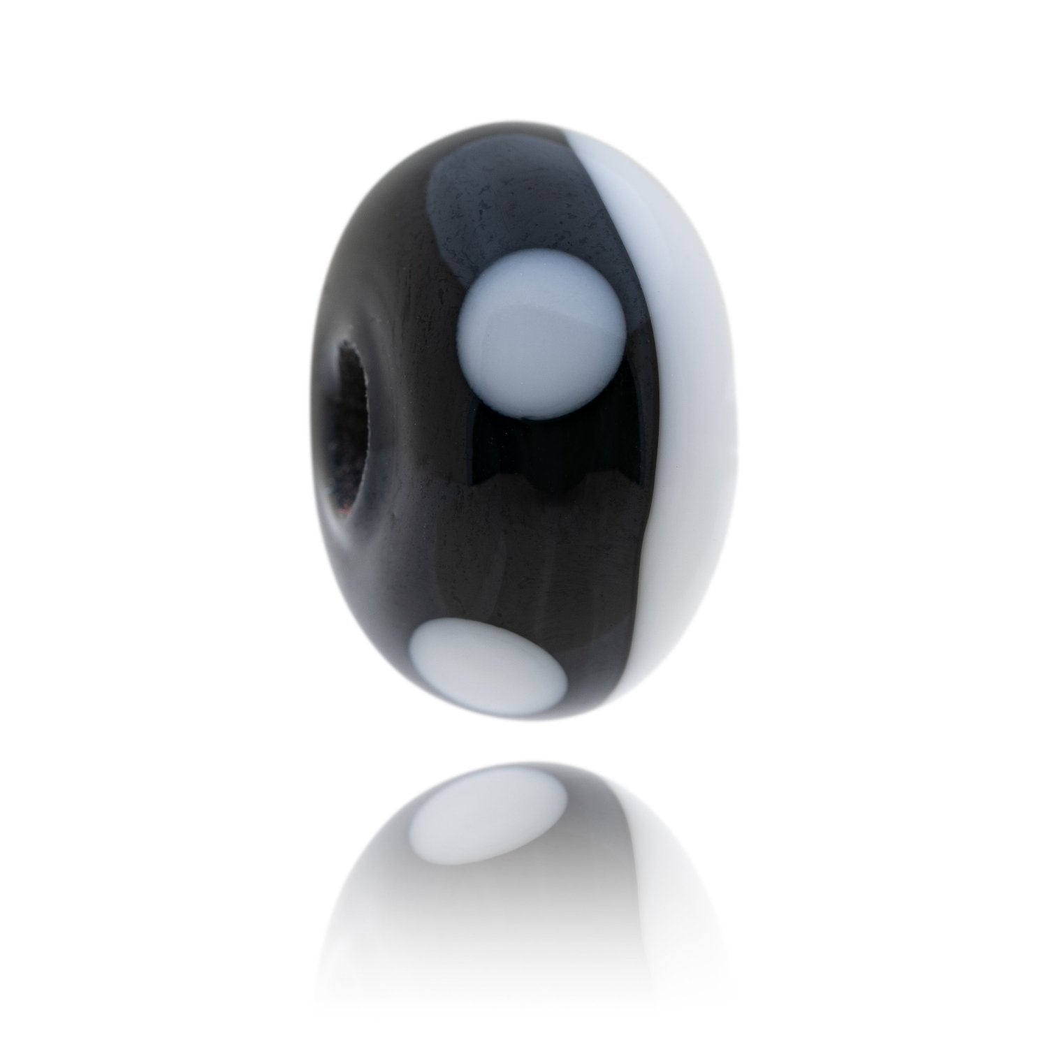 Black and white glass bead representing an Orca whale with proceeds of sales going to the Marine Connection charity.