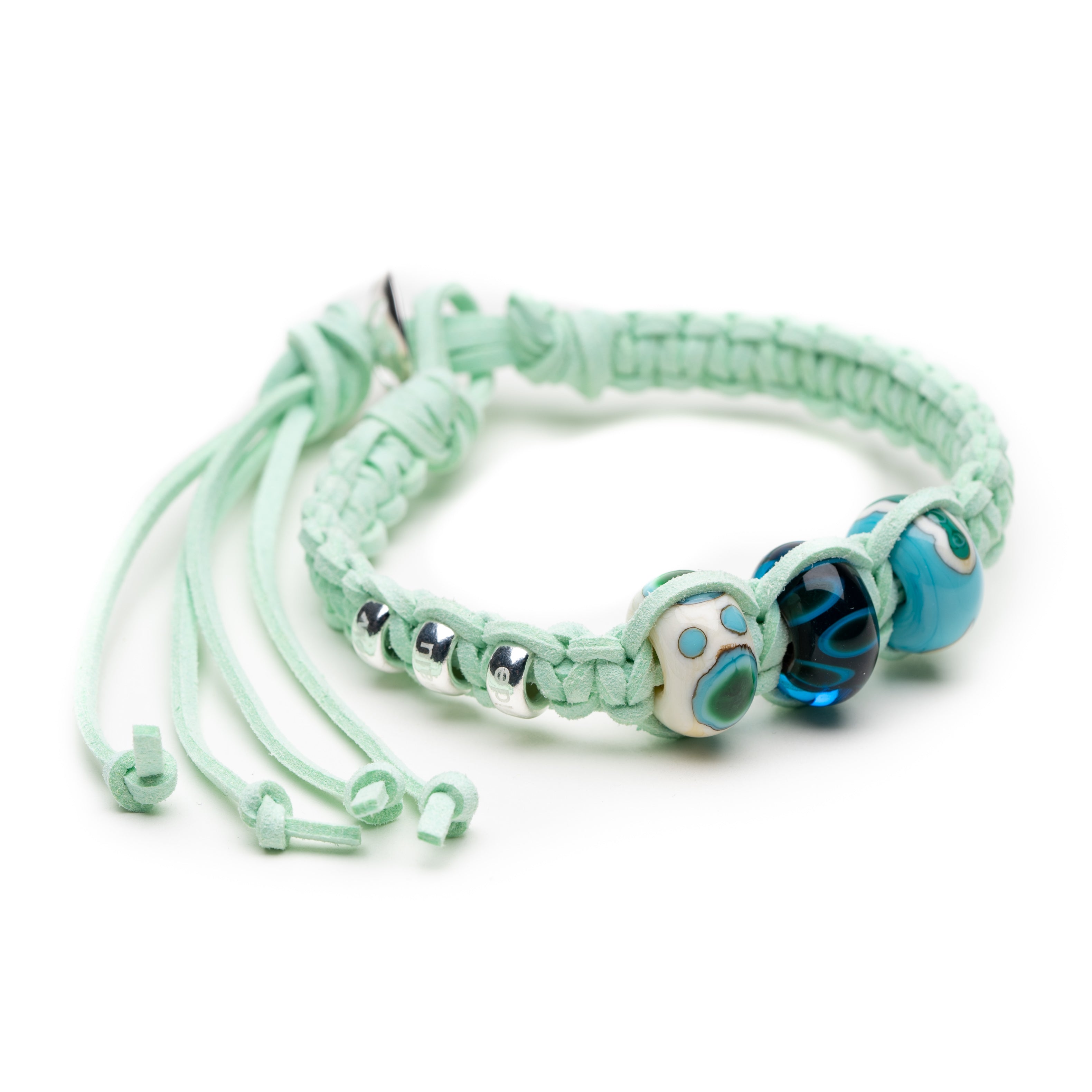 Mint cord bracelet with silver and blue beads.