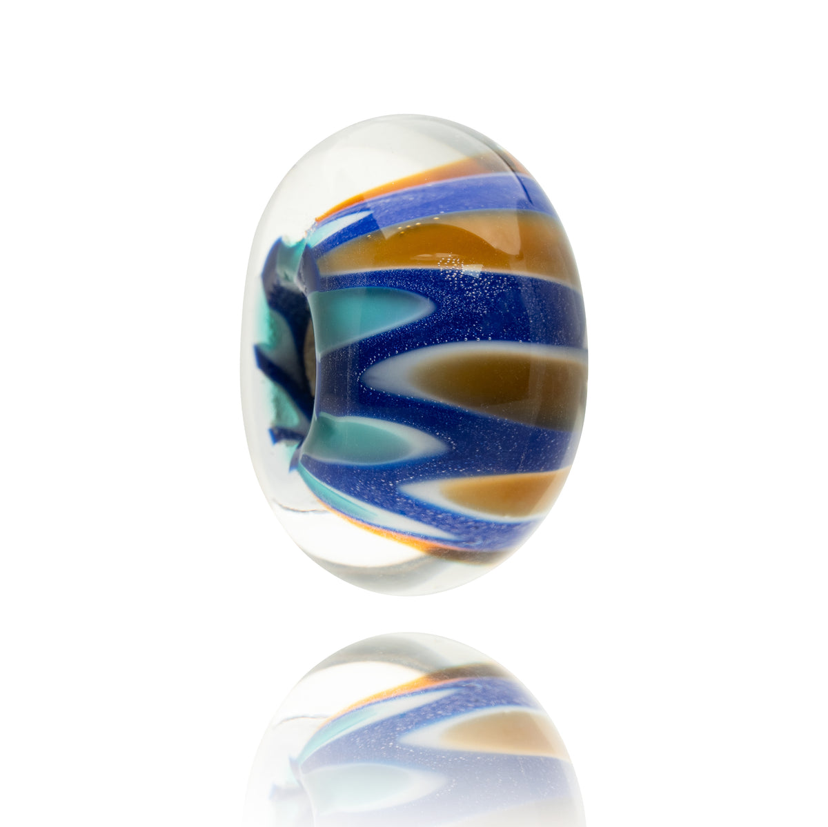 A single oval glass lampwork bead with a clear base and swirled patterns of royal blue, amber orange, and teal, shown on a white background with a soft reflection below.