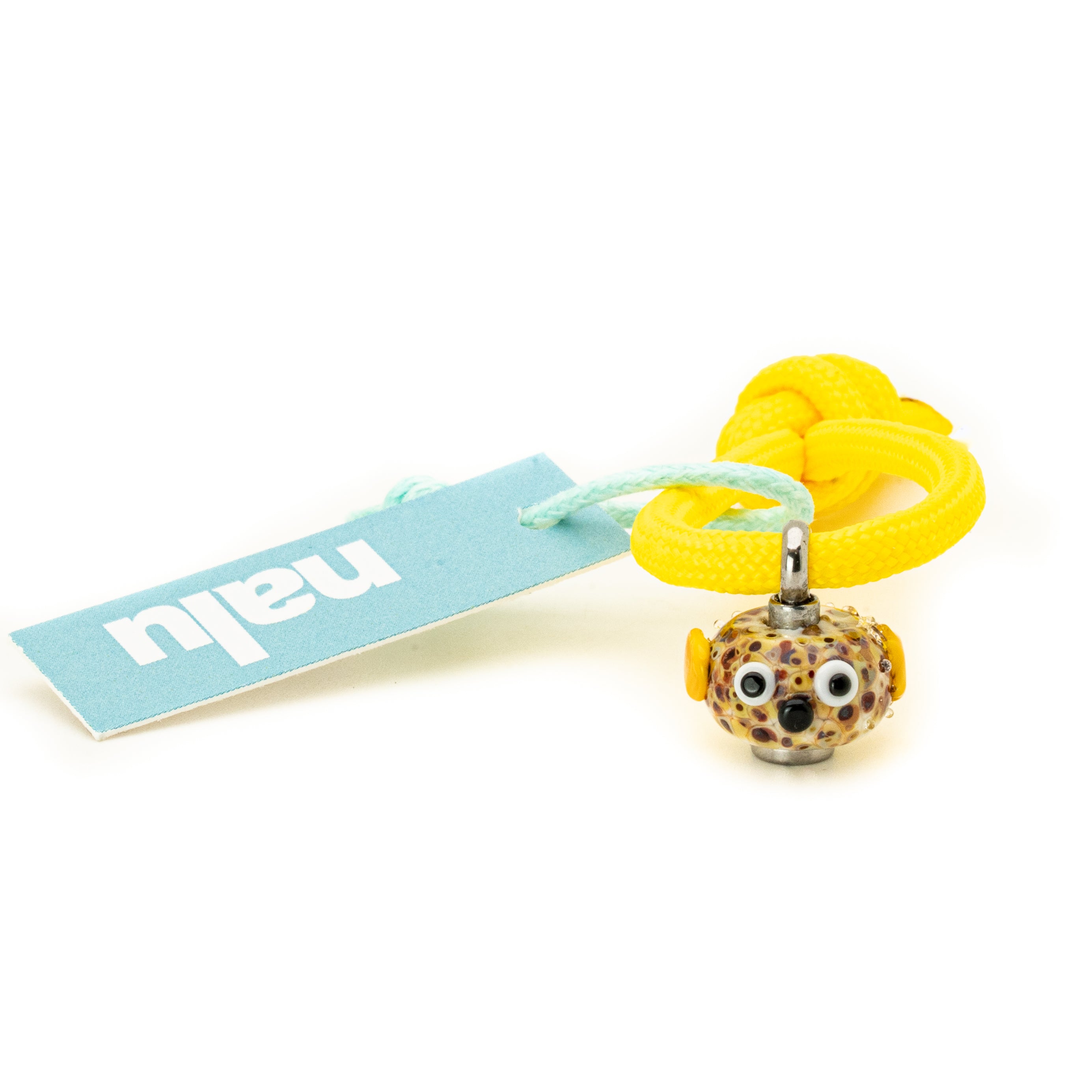 Glass fish bead with leopard print design and yellow rope, featuring a 'nalu' tag on a white background.