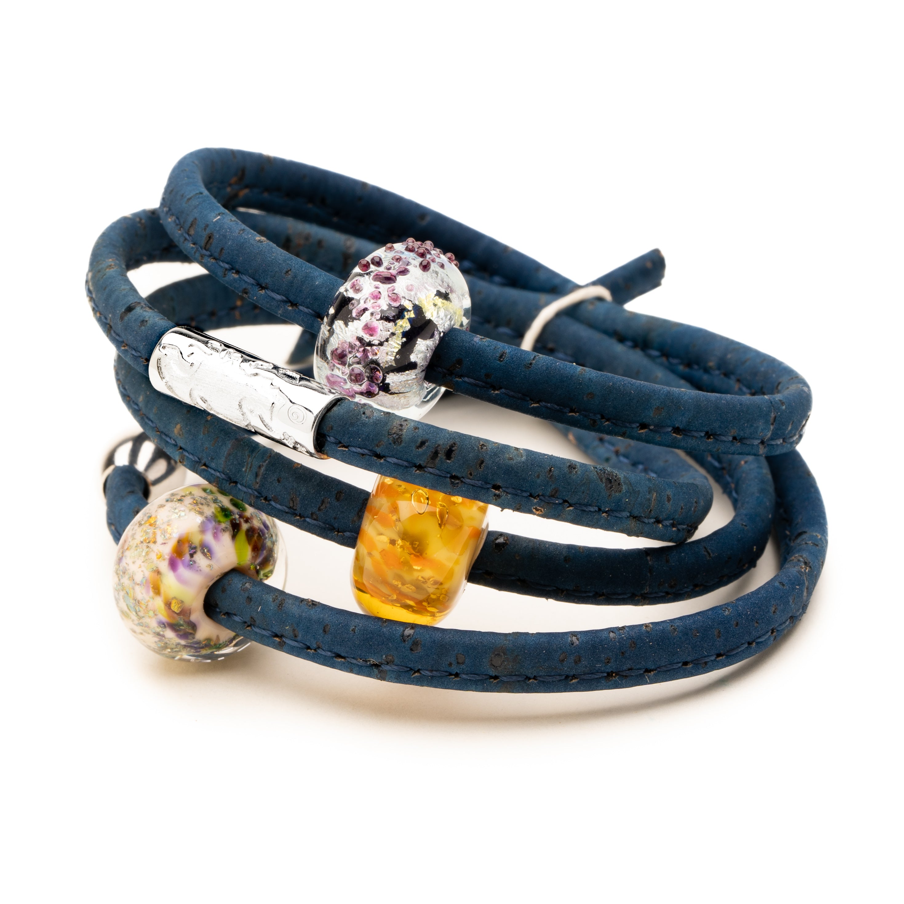 Glass beads on navy cork wrap barcelet on site background.
