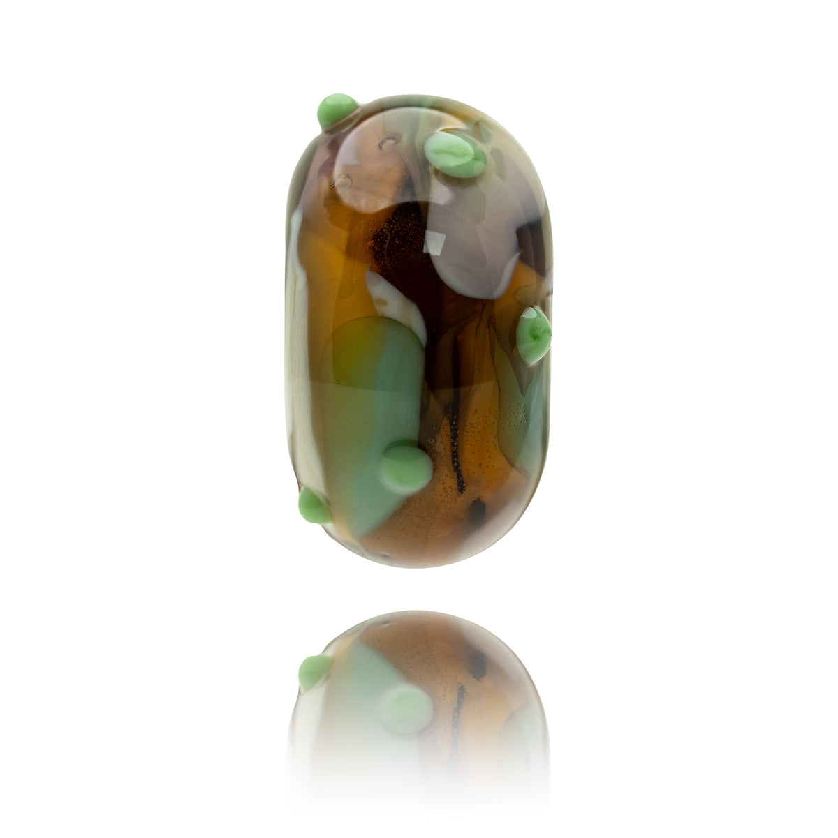 A single glossy glass bead with an elongated oval shape, featuring marbled brown, amber, and olive-green patterns with small light green raised dots, shown on a white background with a soft reflection below.