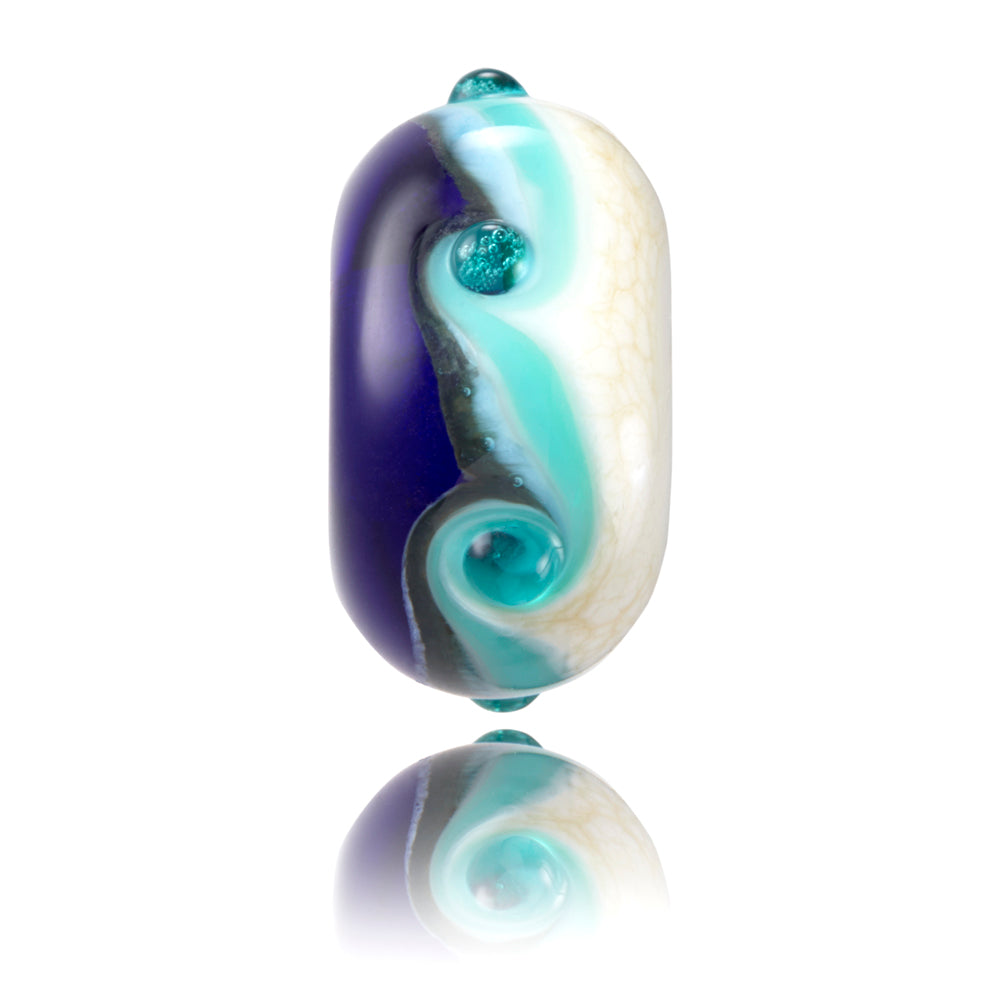 Blue and cream wavy glass bead representing the Ocean Generation charity.