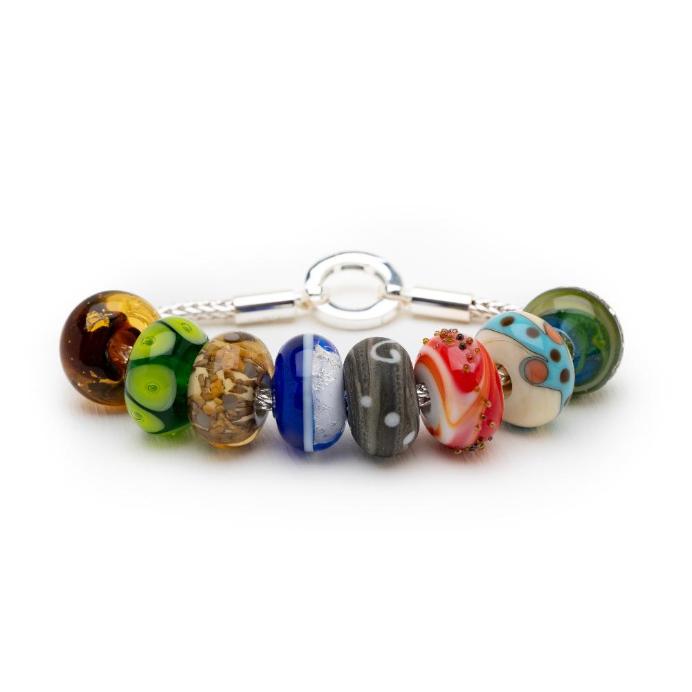 Coloured, pattered glass beads representing UK holiday destinations on silver bracelet, made by Nalu.