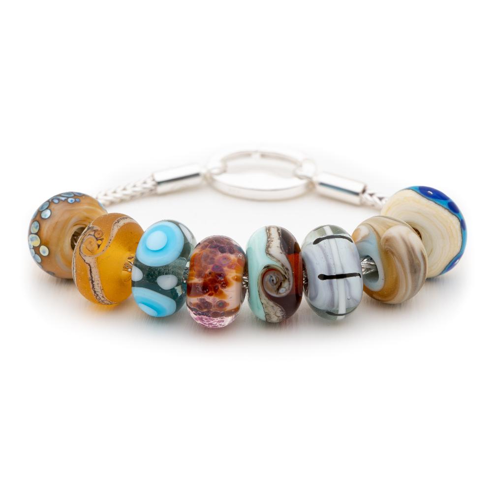 Coloured, pattered glass beads representing UK holiday destinations on silver bracelet, made by Nalu.