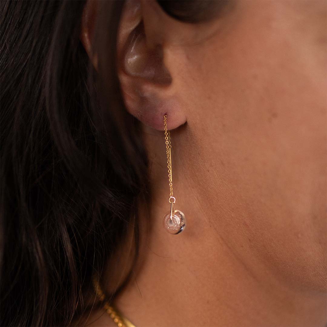 Gold thread through earrings with peach beads.