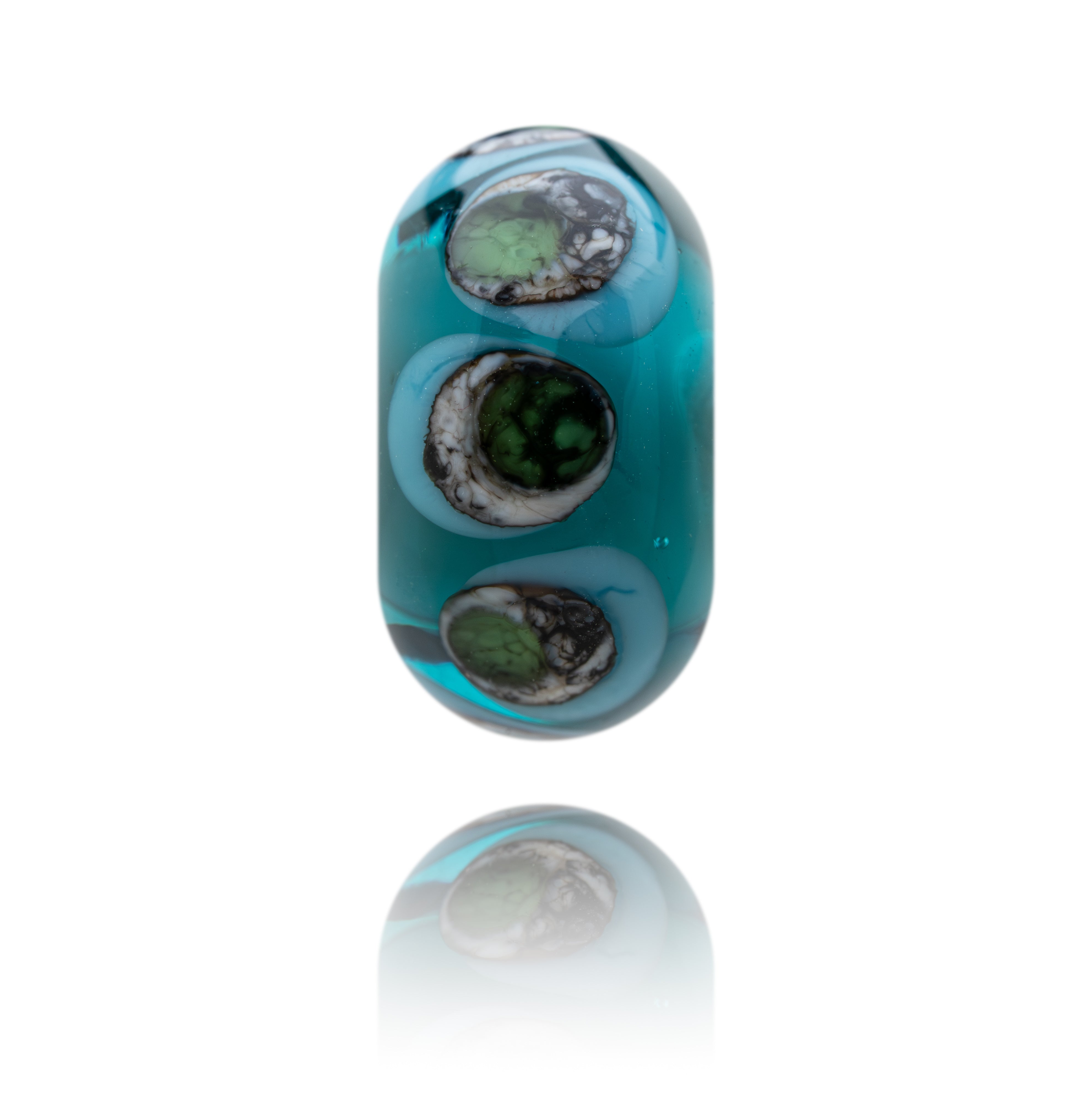 Teal glass bead with black and green patterns on a white background