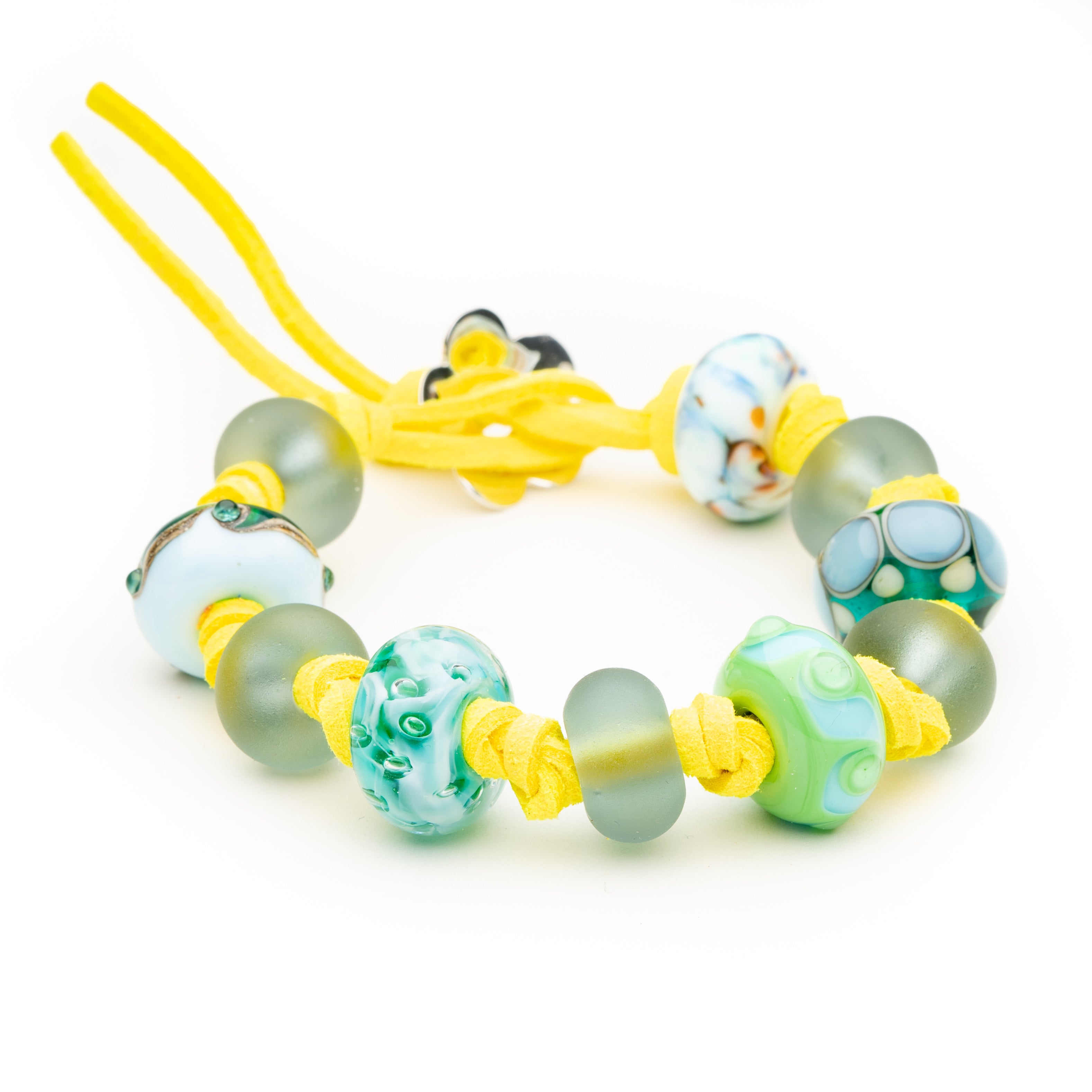 Colourful glass beads on yellow cord bracelet.