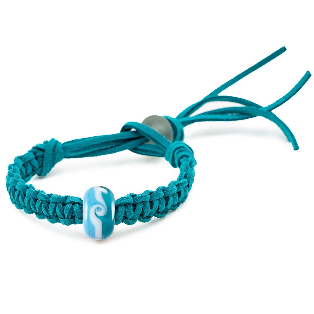 Transparent and opaque glass bead bracelet with a white wave swirl being sold in support of the Surfers Against Sewage charity.