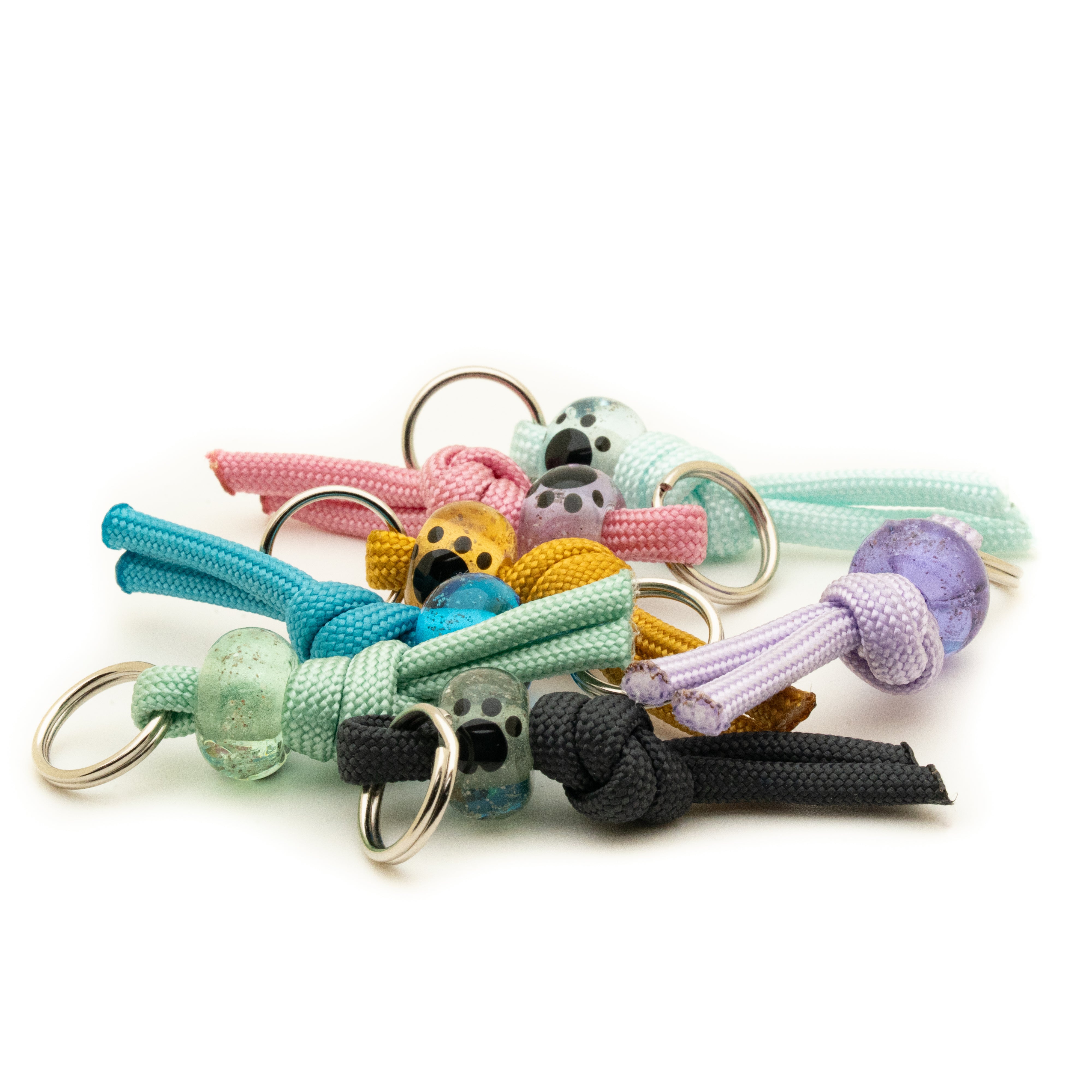 Collection of colourful dog collar charms with various designs on a white background