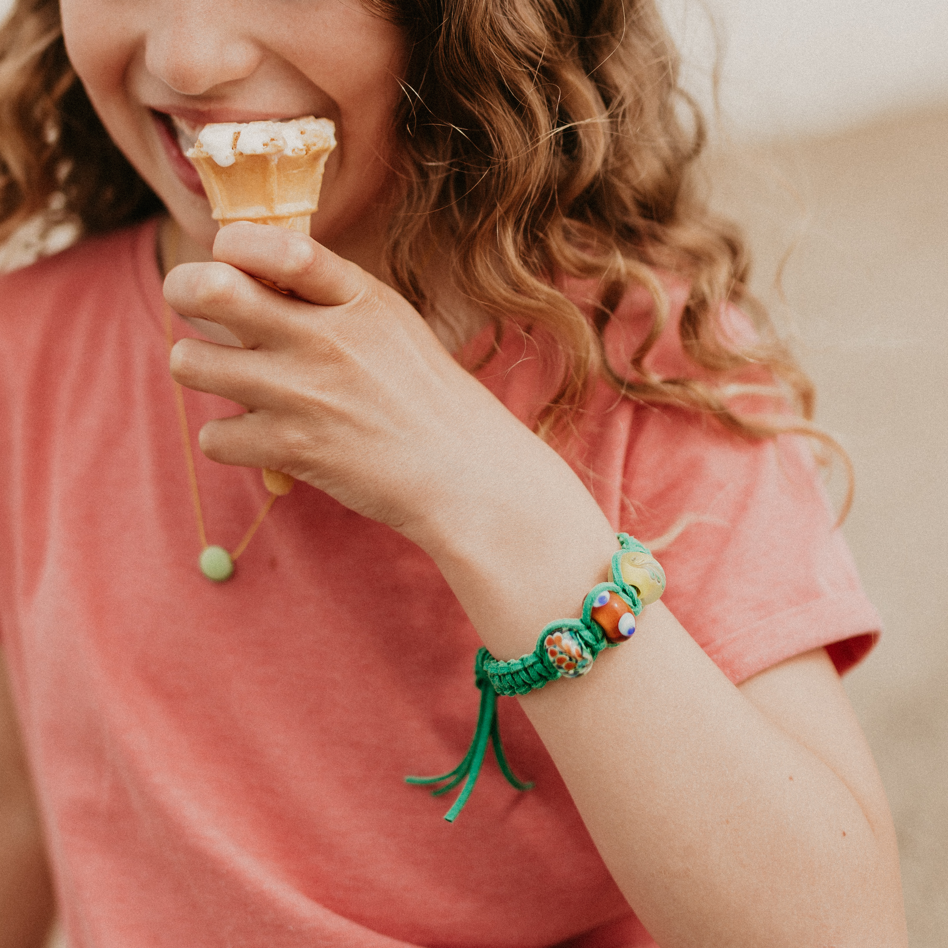 Girl eating ice cream wearing custom cord bracelet.