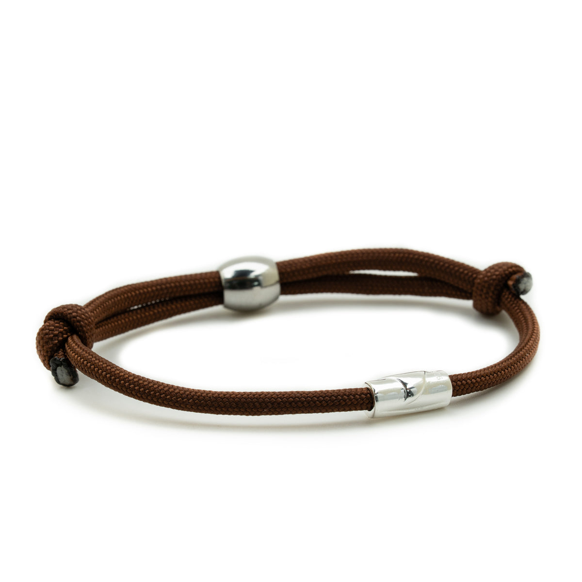 A brown braided cord bracelet with polished silver metal beads and a silver sliding clasp, shown on a clean white background.