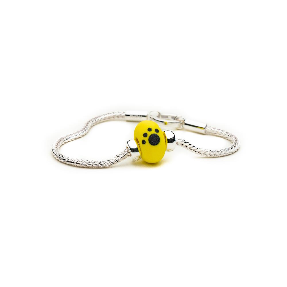 Dogs Trust yellow bead on the silver tulang bracelet.