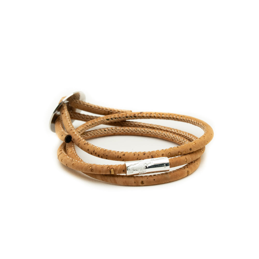 Brown leather bracelet with a silver clasp on a white background