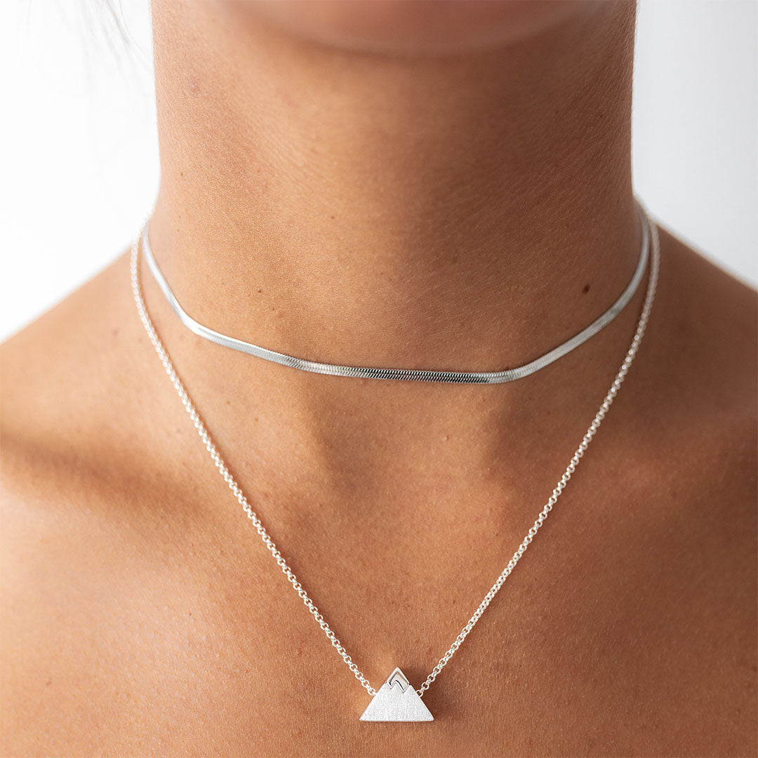 Silver choker necklace with chain necklace with triangle shape charm.