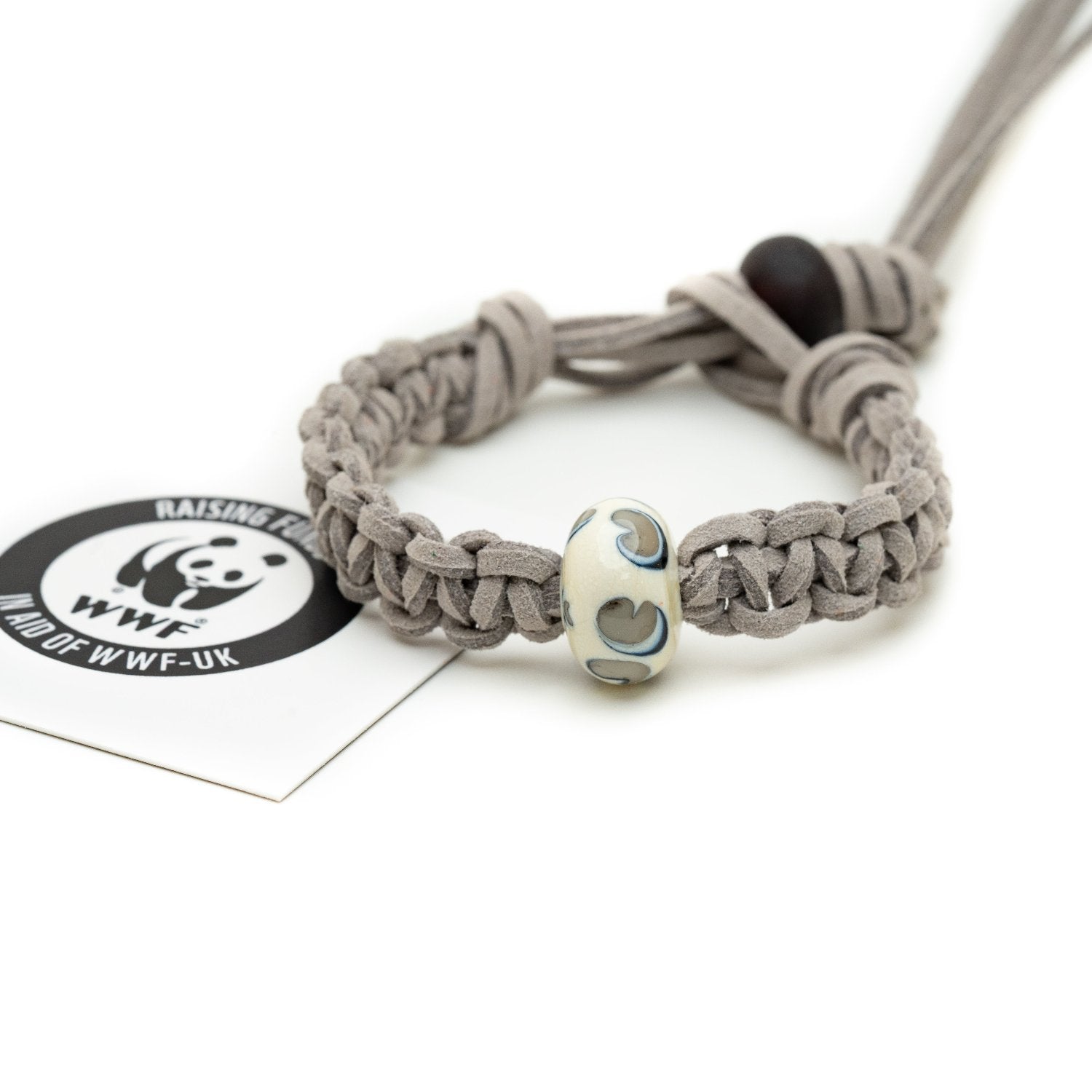 Cream, grey and black glass bead bracelet representing snow leopard being sold to raise funds for the World Wildlife Foundation.