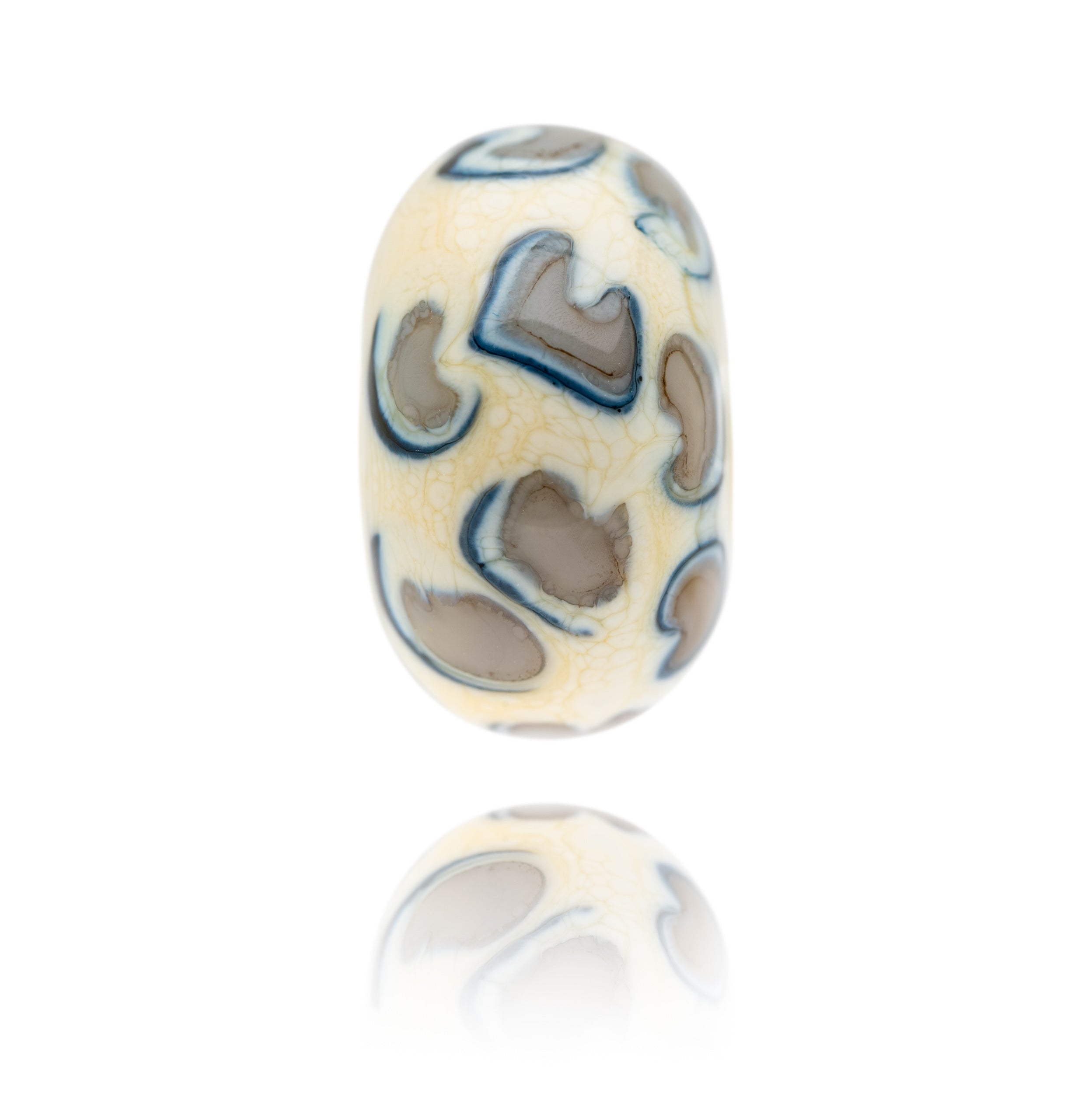 Cream, grey and black glass bead representing snow leopard being sold to raise funds for the World Wildlife Foundation.