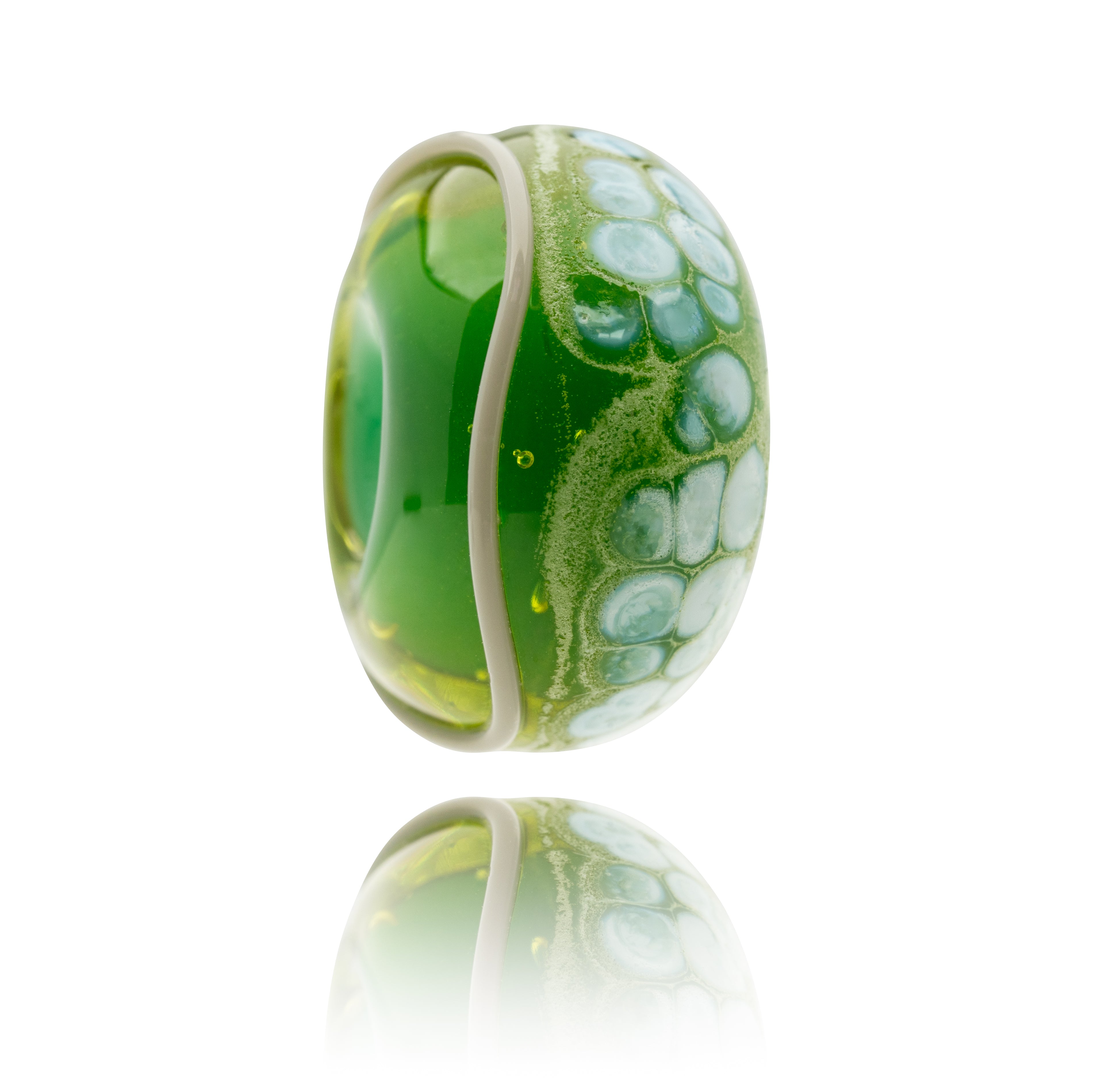 Green glass bead with white dots on the surface and a grey stripe.