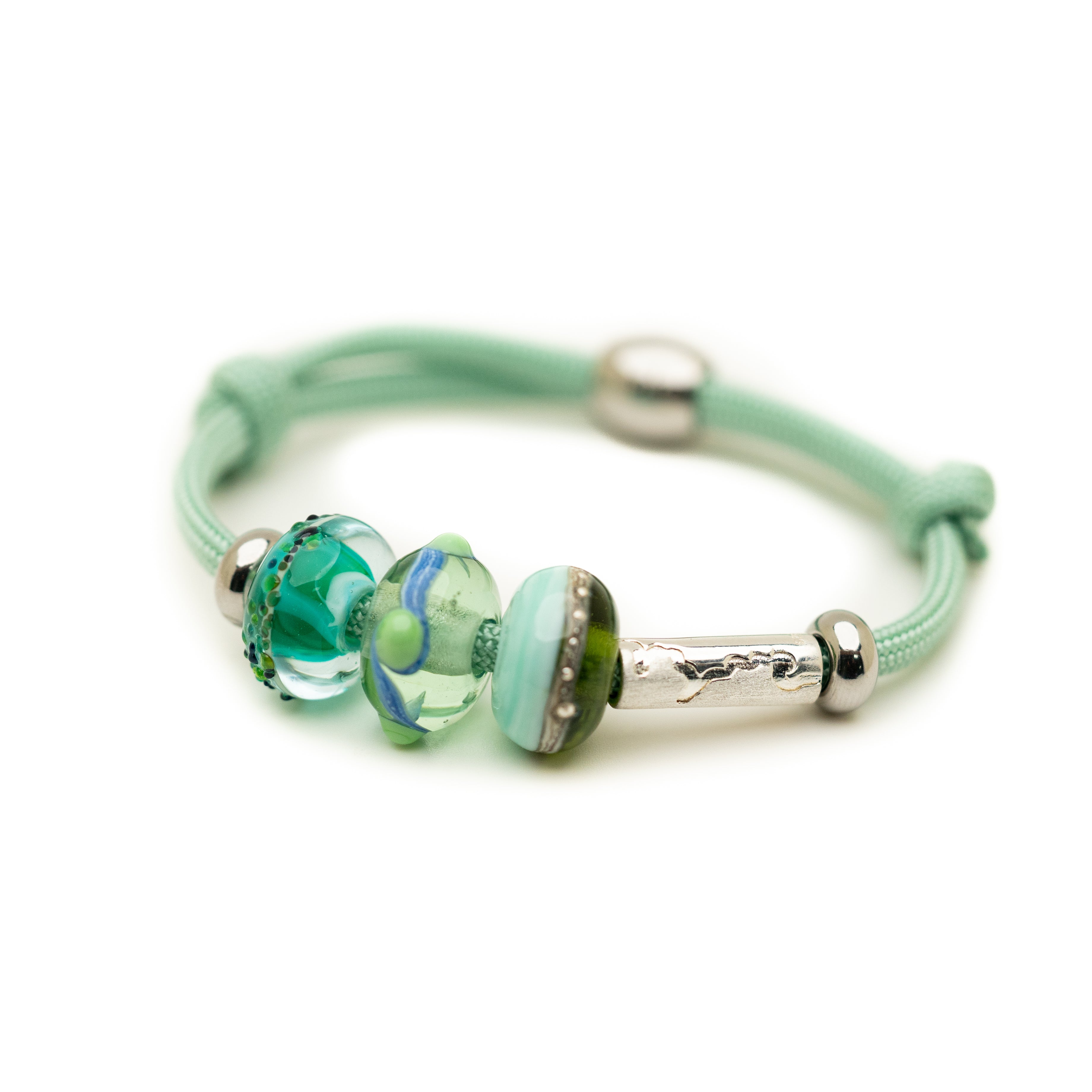 Green glass beads on green mint cord bracelet.