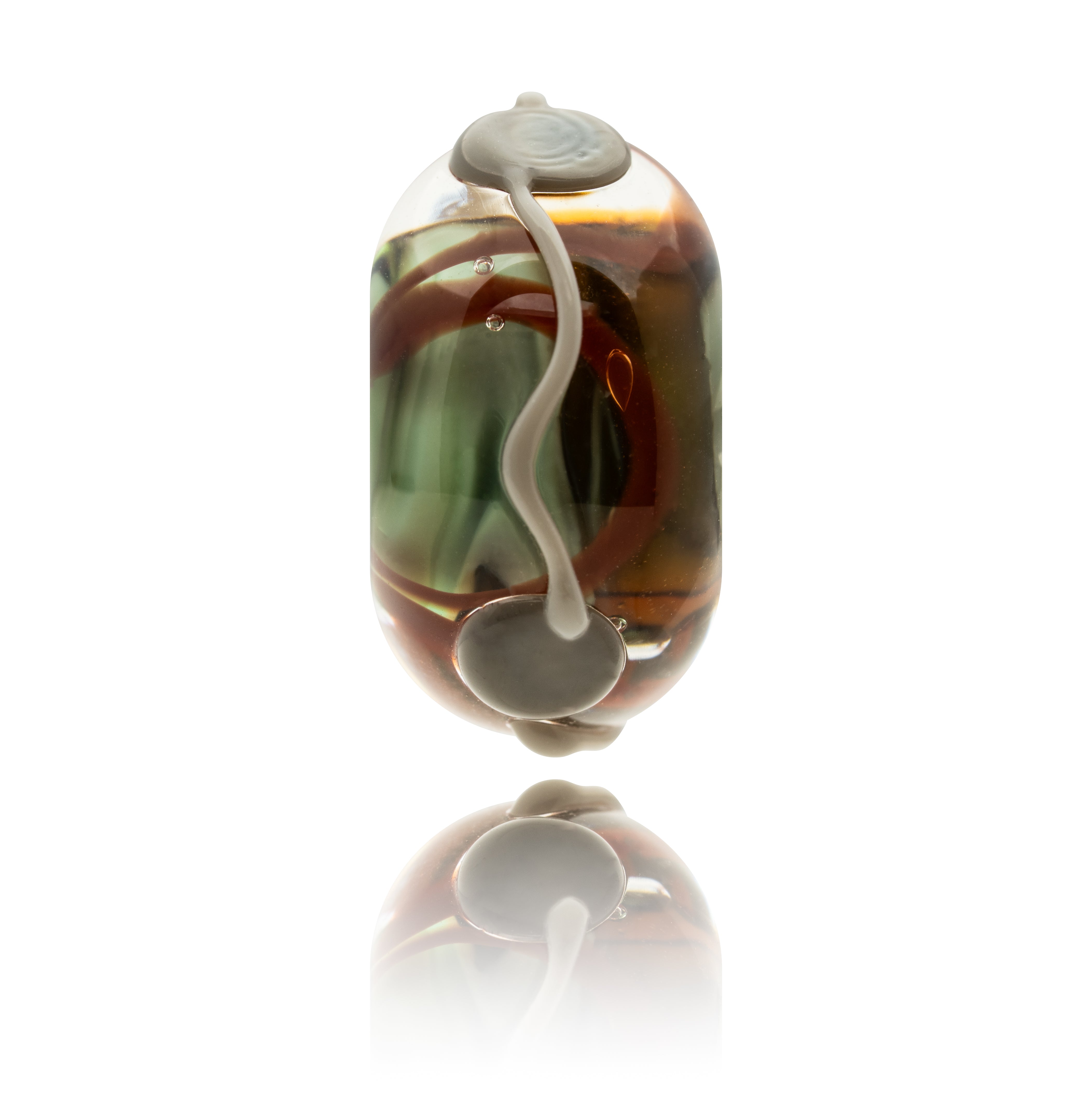 Glass bead with brown and green swirls on a white background