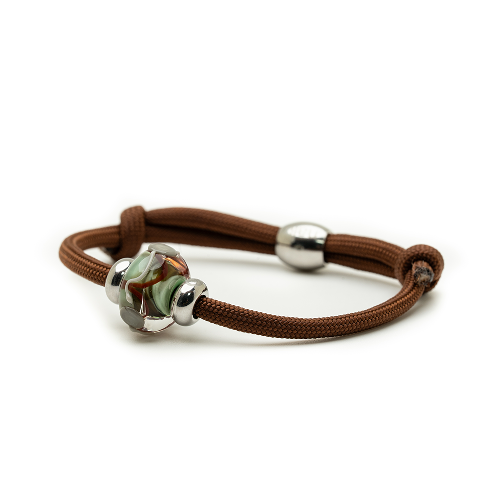 Brown bracelet with silver beads on a white background